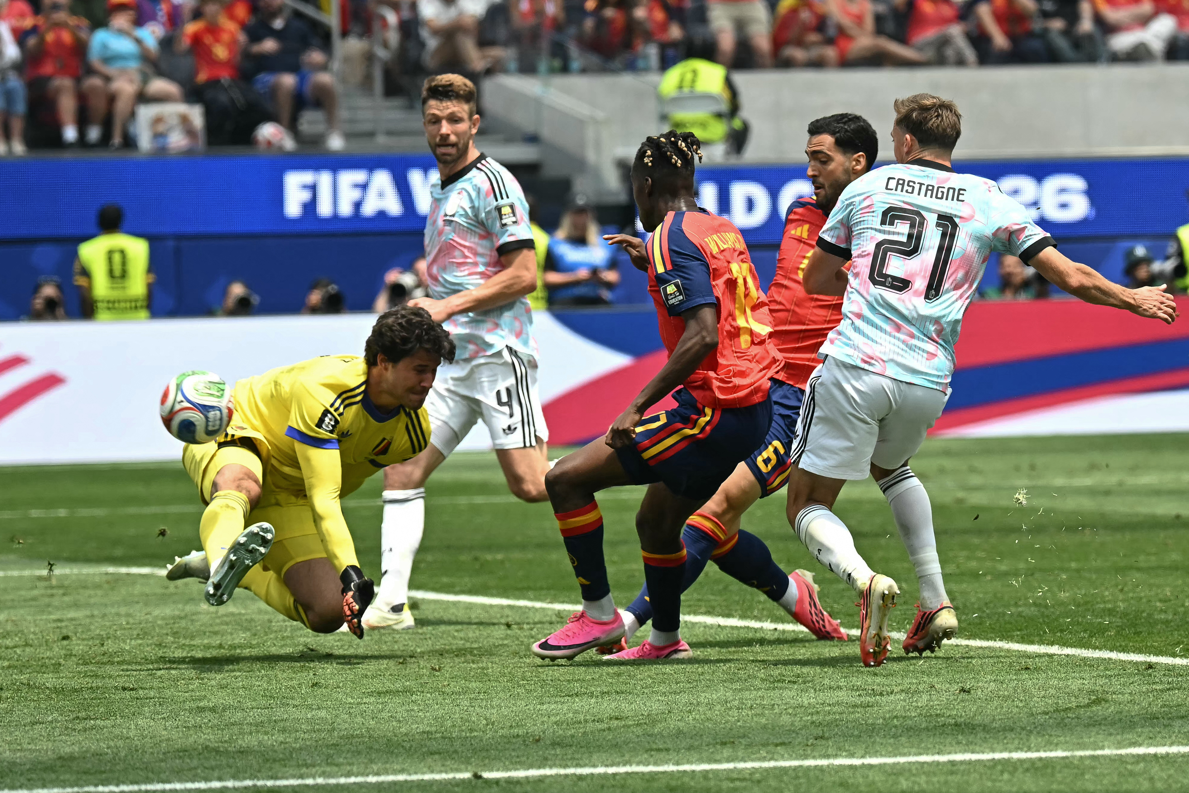 Spain’s Mikel Merino, second from right, scores the match-winner against Belgium keeper Senne Lammens in the quarterfinal in Inglewood on July 10, 2026