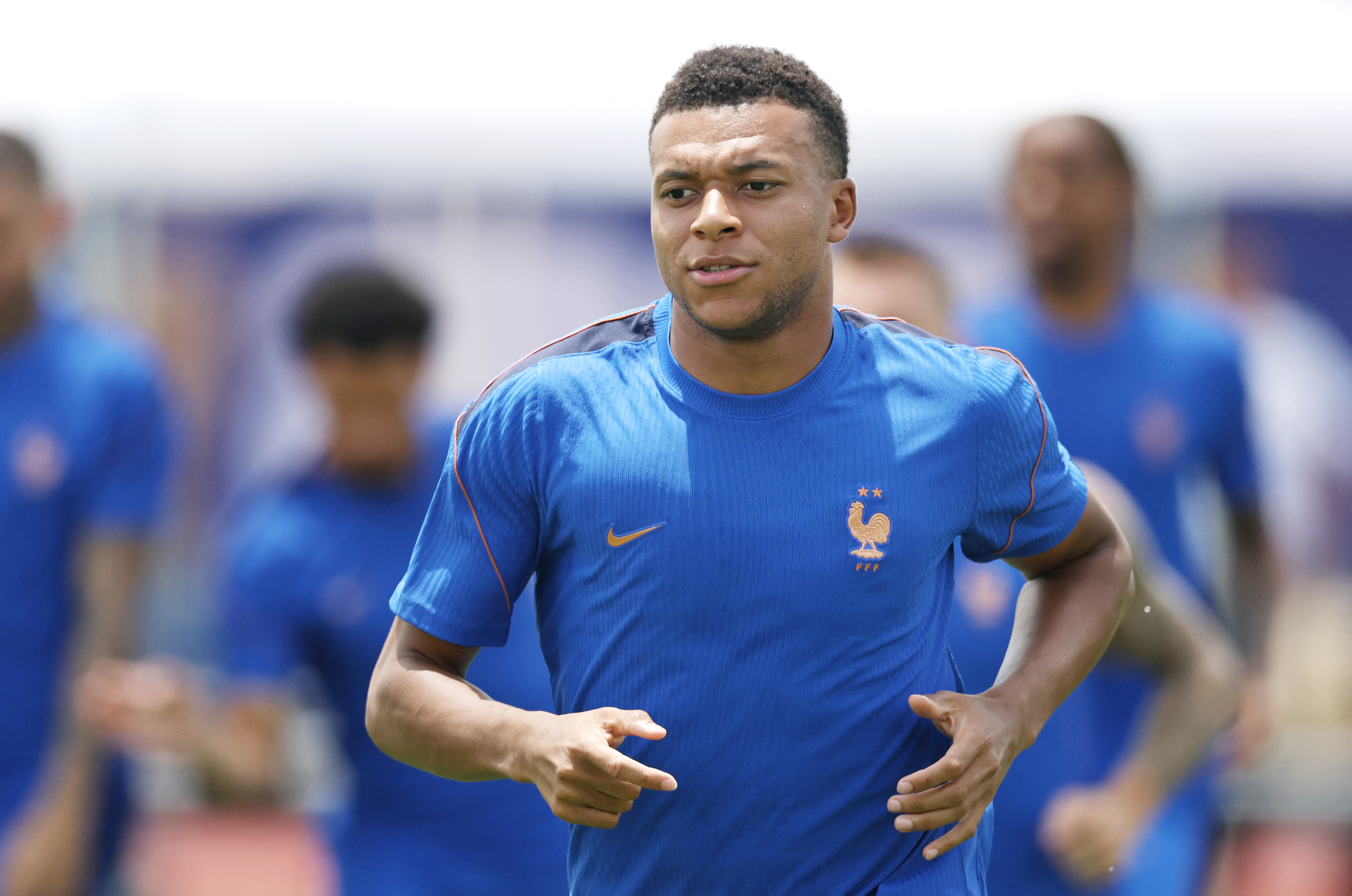 A football player runs during training on the field