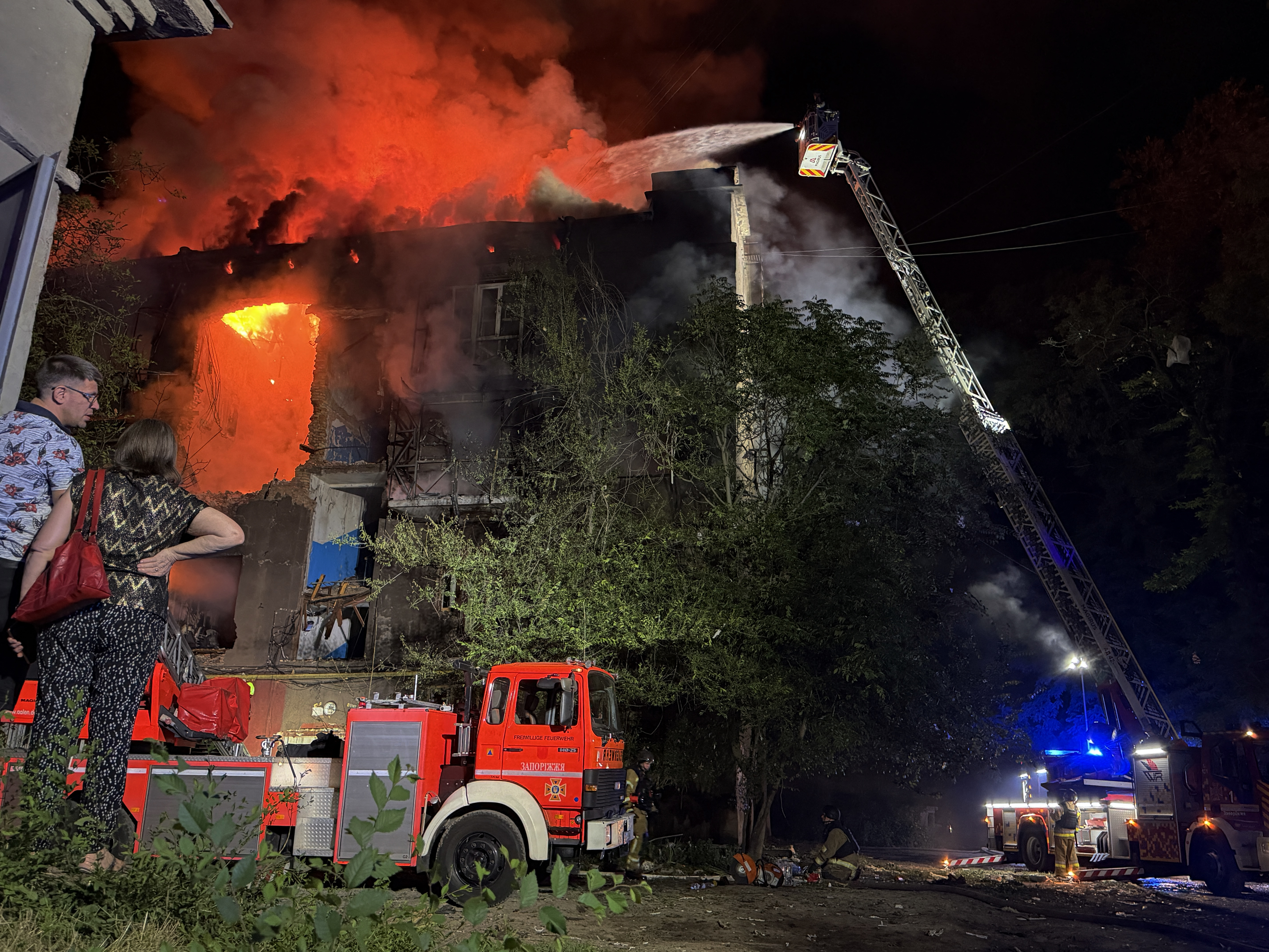 Ukrainian rescuers work to extinguish a fire at a damaged residential building following a Russian drone strike late night in Zaporizhzhia on July 12, 2026, amid the Russian invasion of Ukraine.