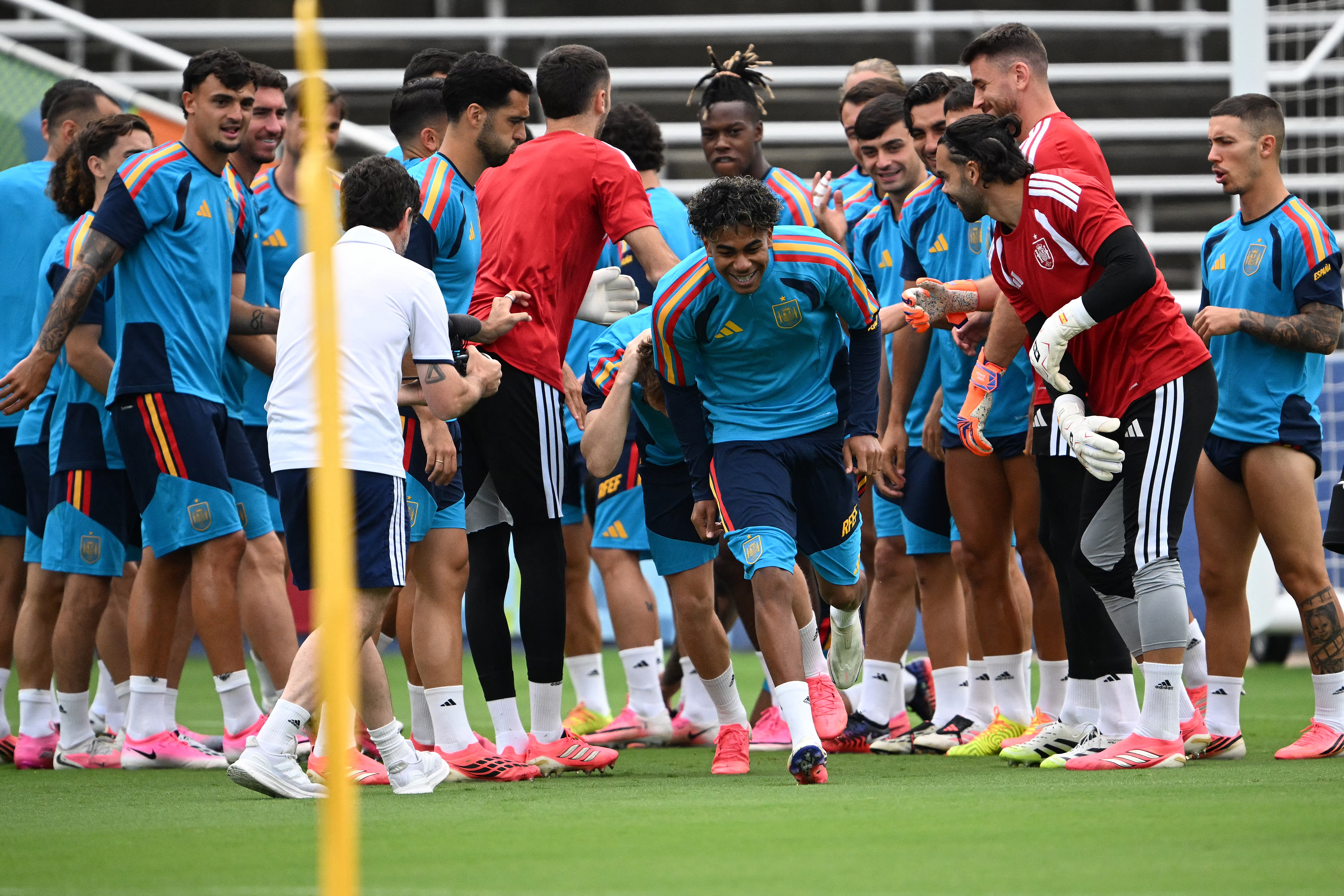 Spain players form a guard of honor for Spain's forward Lamine Yamal (C) to celebrate his birthday during a training session on the eve of the 2026 World Cup football tournament semi-final match between France and Spain at the Cotton Bowl Stadium in Dallas on July 13, 2026. (Photo by MAURO PIMENTEL / AFP)