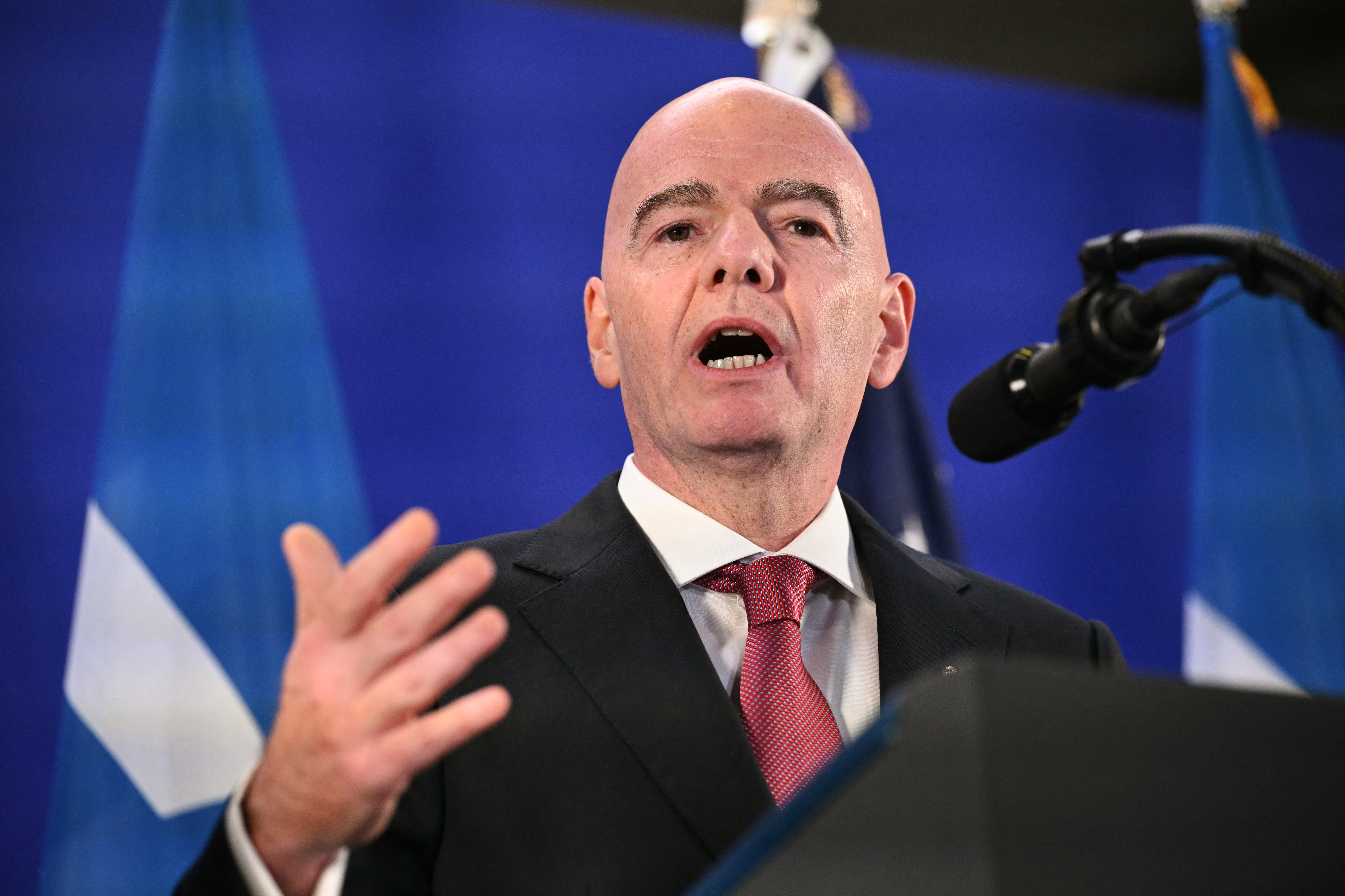 A man at a podium speaks into a microphone