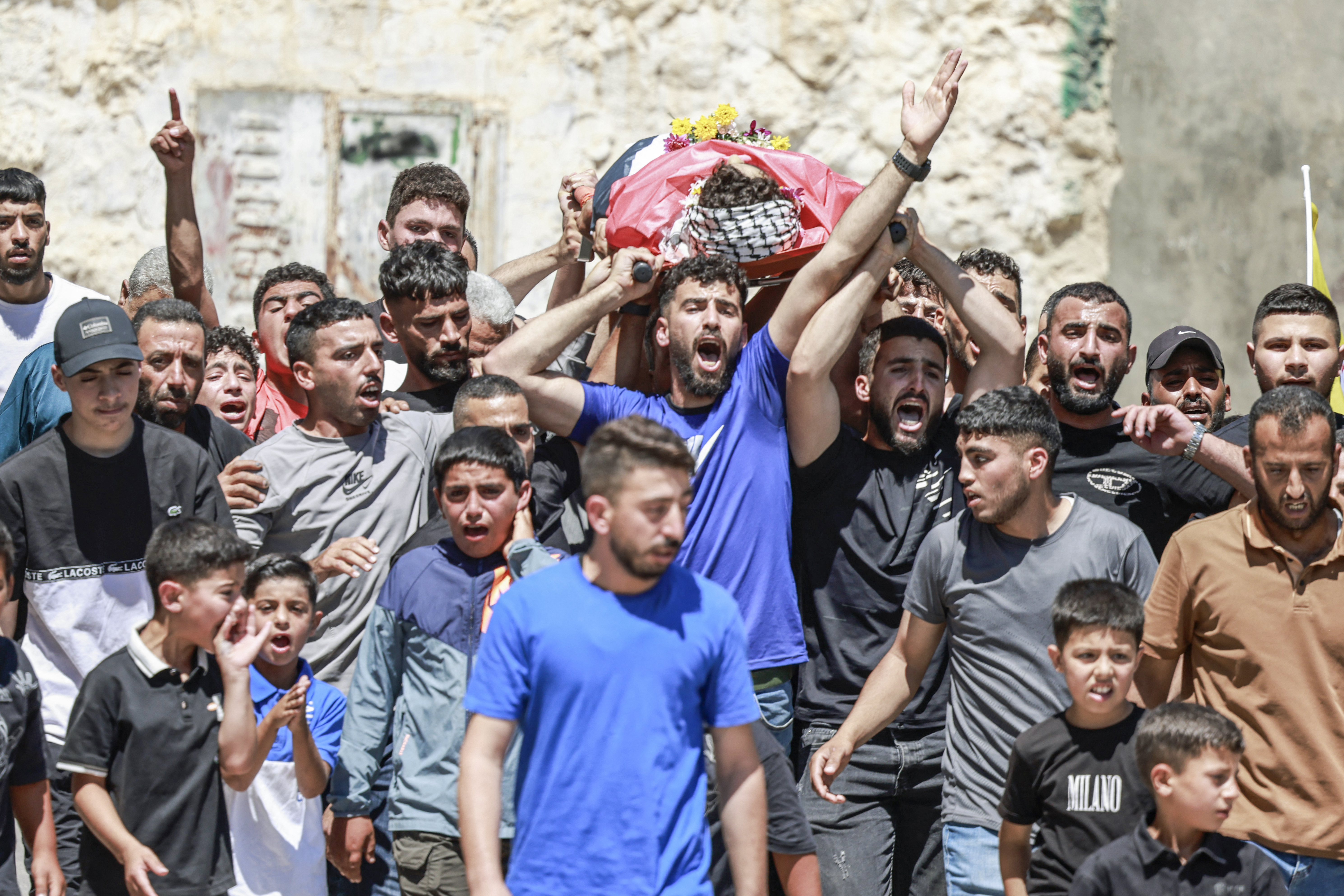 EDITORS NOTE: Graphic content / Mourners carry the body of 17-year-old Fadi al-Naasan during his funeral in the village of Al-Mughayyir, east of Ramallah in the Israeli-occupied West Bank, on July 18, 2026, after he died from wounds sustained about a week ago during clashes with Israeli forces. The occupied West Bank has been gripped by almost daily violence involving Israeli troops and settlers since the start of the Gaza war in October 2023. (Photo by Jaafar ASHTIYEH / AFP)