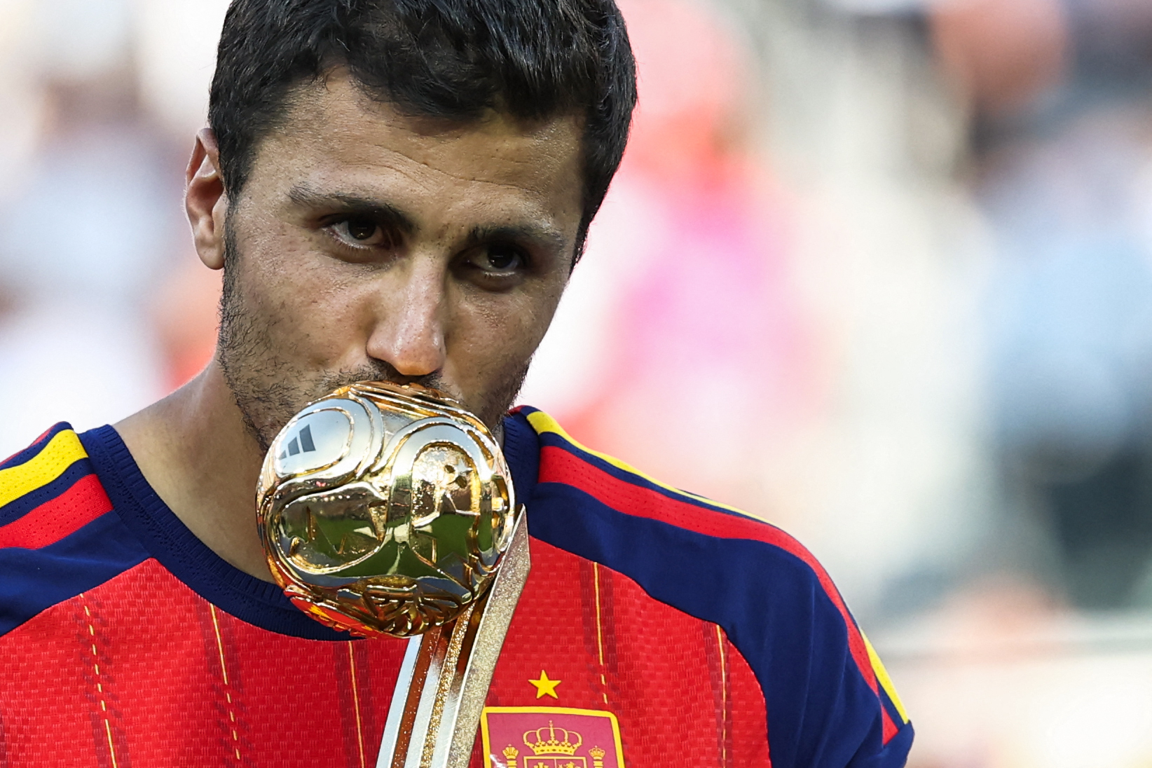 Spain's midfielder #16 Rodri kisses the Golden Ball Award during the award ceremony of the 2026 World Cup football tournament final match between Spain and Argentina at the New York/New Jersey Stadium in East Rutherford on July 19, 2026. (Photo by FRANCK FIFE / AFP)
