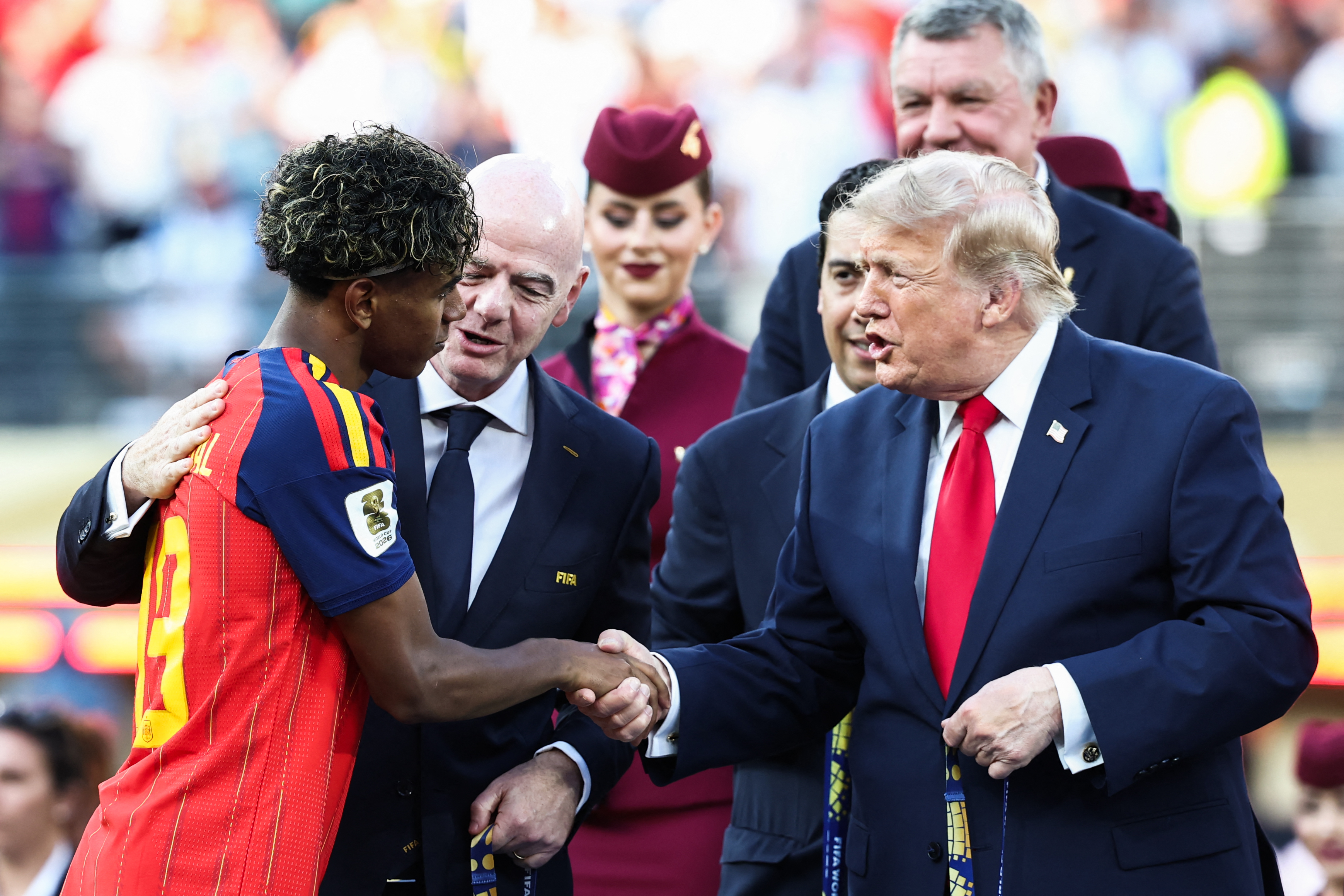 Spain's forward #19 Lamine Yamal (L) and US President Donald Trump (R) shake hands next to FIFA President Gianni Infantino (C) during the award ceremony of the 2026 World Cup football tournament final match between Spain and Argentina at the New York/New Jersey Stadium in East Rutherford on July 19, 2026. (Photo by FRANCK FIFE / AFP)
