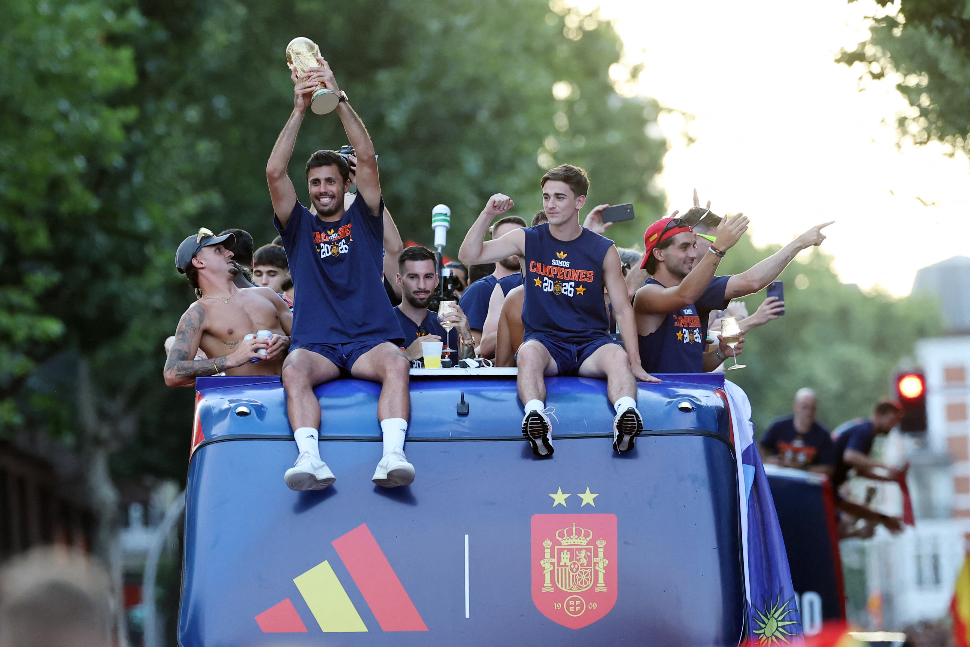 Spain's midfielder Rodri holds their trophy as Spain's players parade onboard an open-top bus through the streets of Madrid on July 20, 2026, one day after the national football team won their second World Cup title following a 1-0 victory against Argentina. Spain's World Cup winners come back home to a heroes' welcome in Madrid, where a million fans are expected to greet them after a night of raucous celebrations across the country. (Photo by Thomas COEX / AFP)