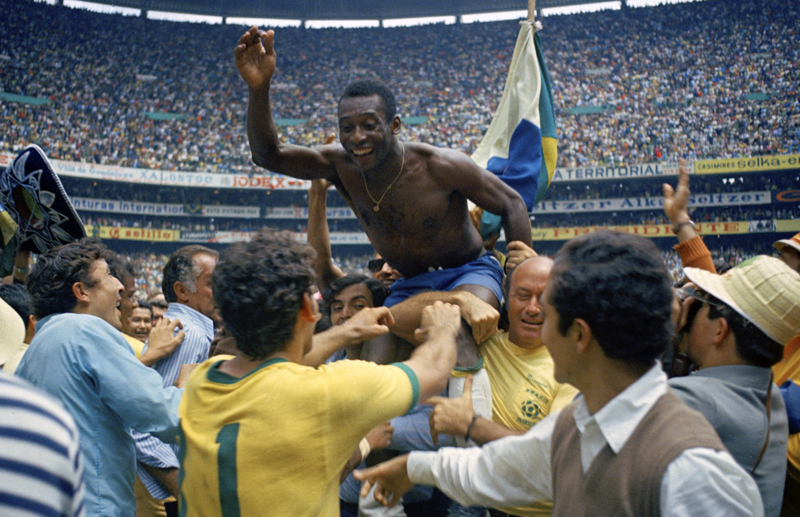 Brazil’s Pele is hoisted on the shoulders of his teammates after Brazil won the 1970 World Cup final against Italy [AP]