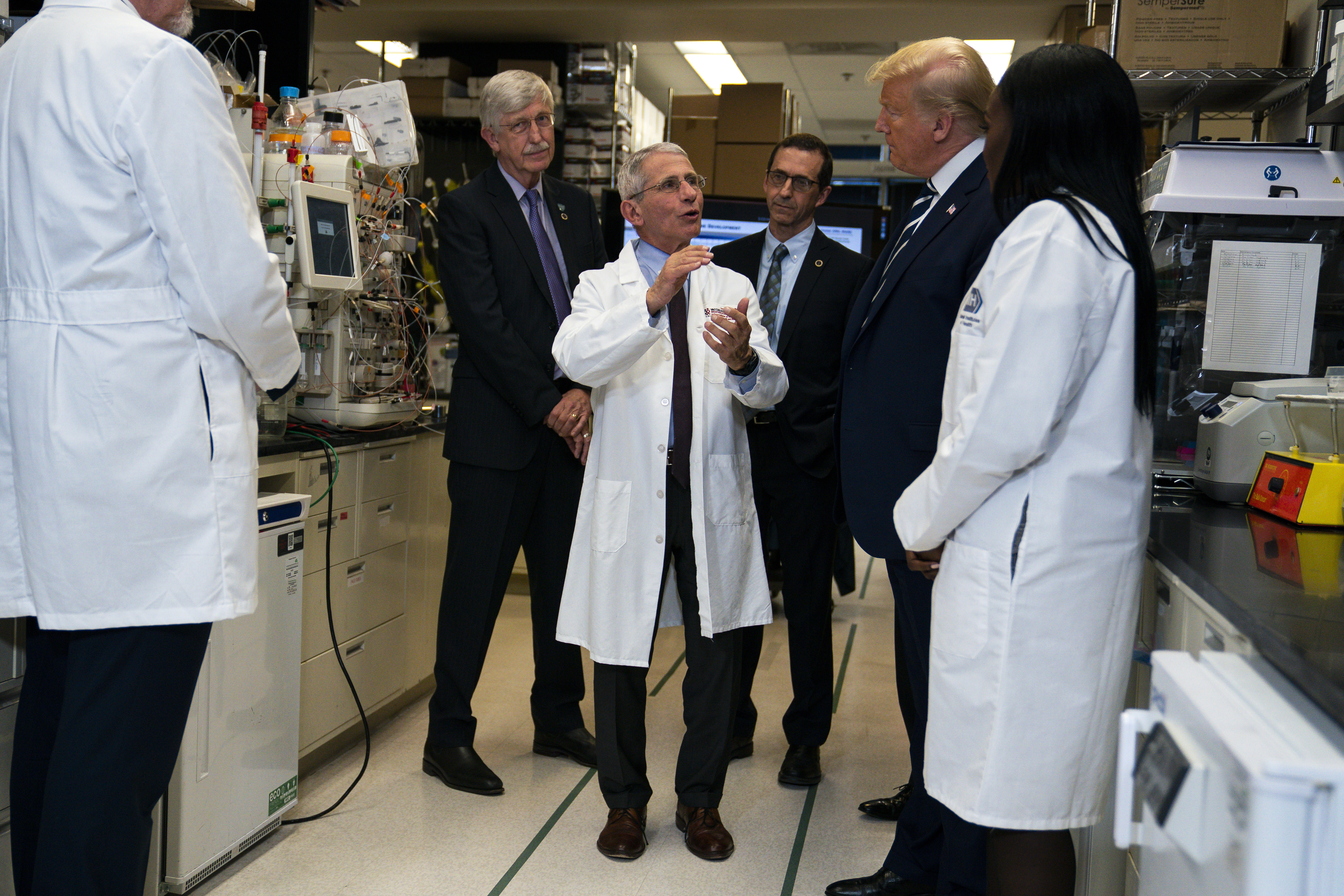 Anthony Fauci, director of the National Institute of Allergy and Infectious Diseases, talks with President Donald Trump in March 2020