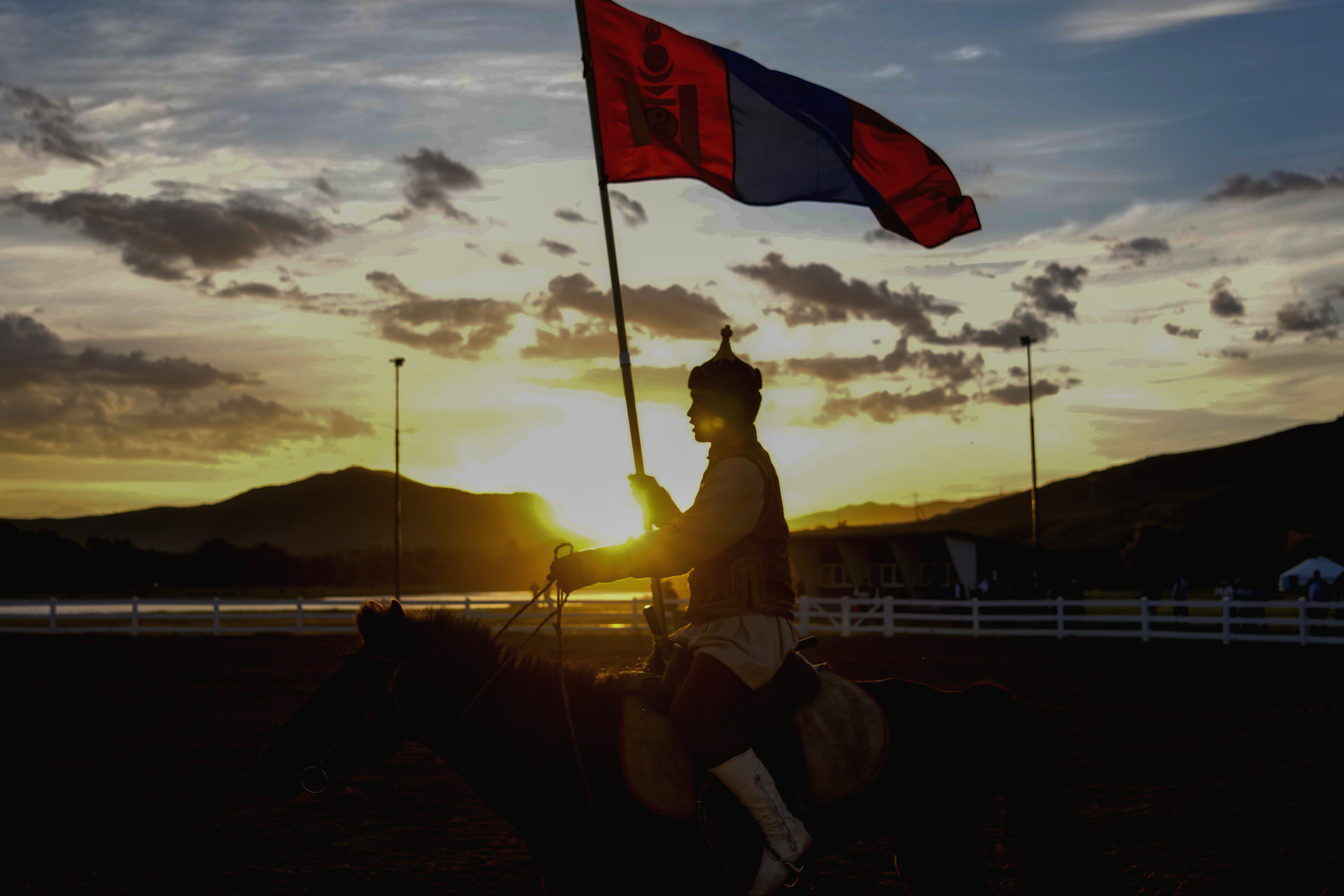 A horse rider holds a Mongolian flag during a traditional performance at a cultural event organized for the media and entourage following Pope Francis' visit to Mongolia, at the Mongolia Cultural Park, some 40 kilometers out of Ulaanbaatar, Mongolia, Friday, Sept. 1, 2023.