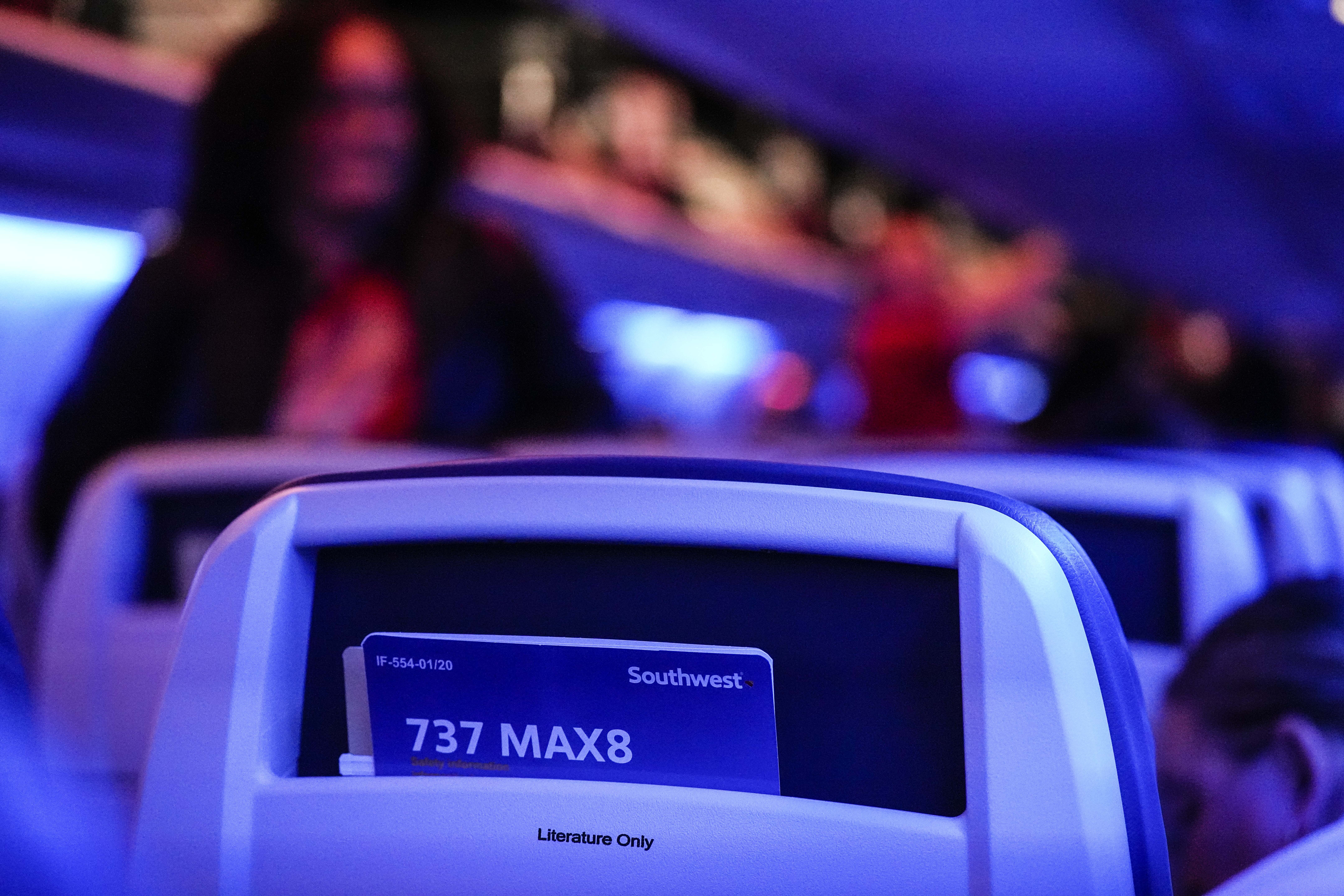 A passanger walks to their seat aboard a SouthWest Airlines 737 Max 8 airplane, Friday, Feb. 9, 2024, in Atlanta. (AP Photo/Mike Stewart)