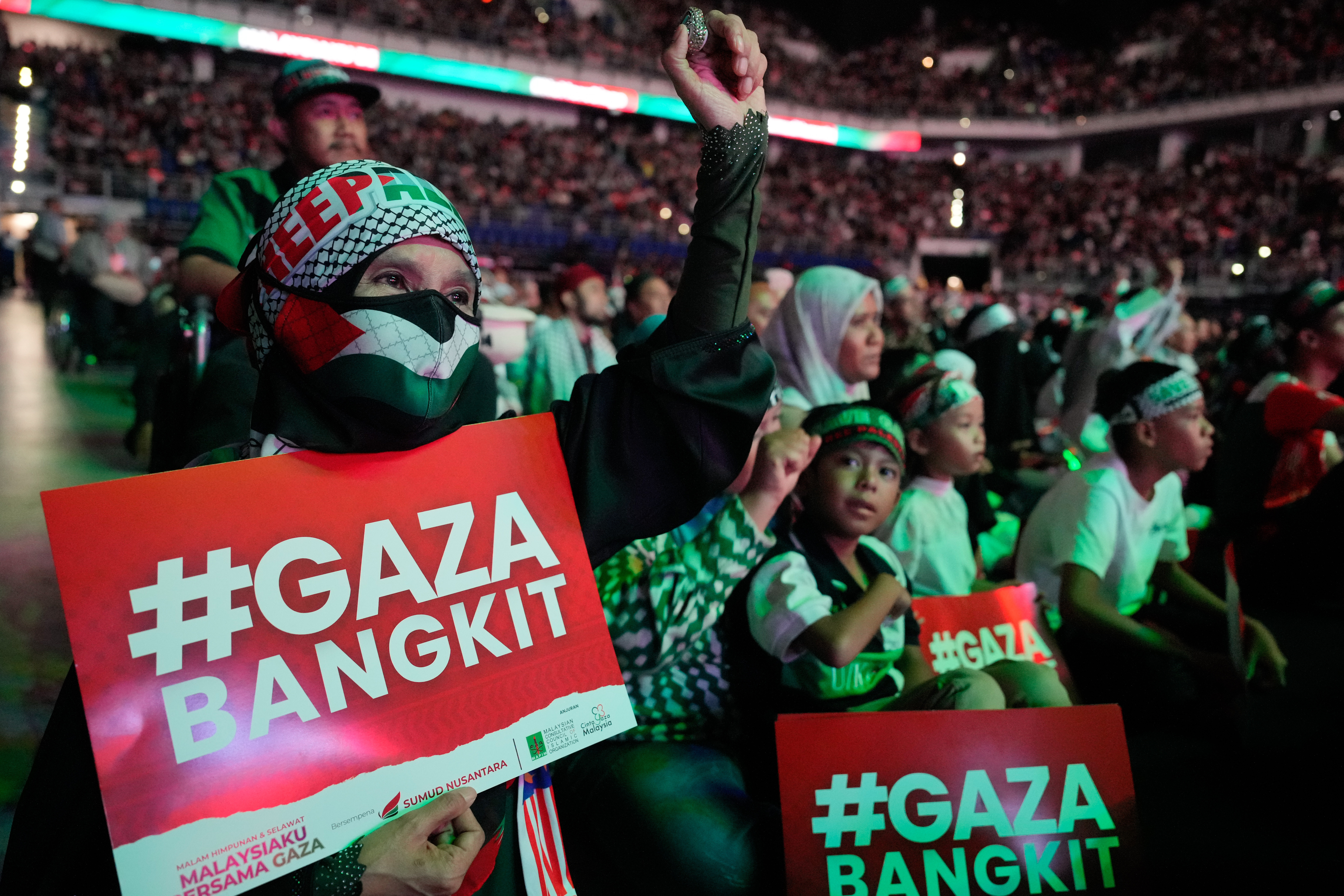 A Malaysian Muslim woman wears a face mask with Palestinian flags during a rally to celebrate Malaysian Global Sumud Flotilla activists at an indoor stadium in Kuala Lumpur, Malaysia, on October 8, 2025
