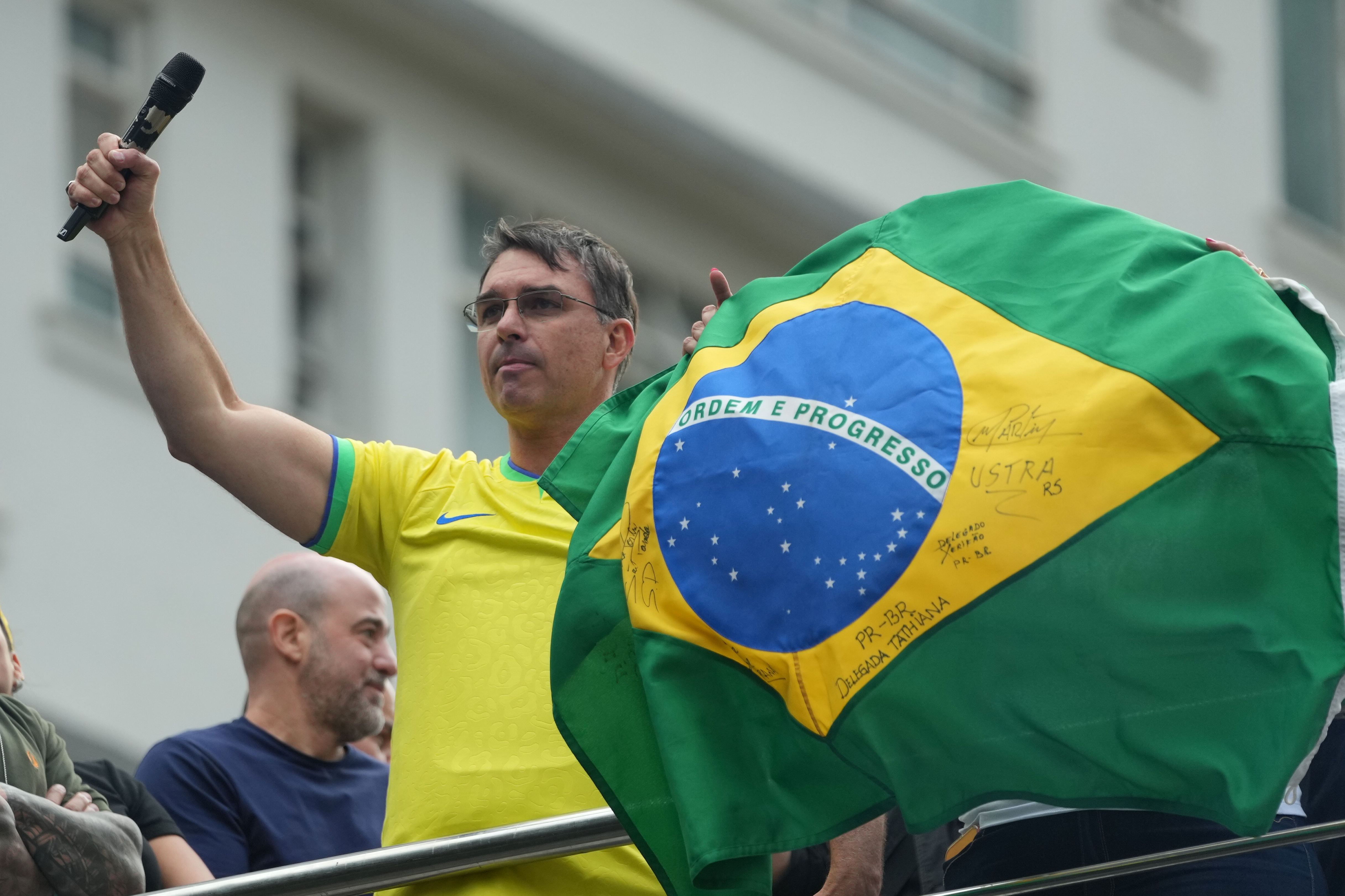 Sen. Flavio Bolsonaro, son of former President Jair Bolsonaro and a candidate in Brazil's October presidential election, gestures during a protest against President Luiz Inácio Lula da Silva in Sao Paulo, Sunday, March 1, 2026. (AP Photo/Andre Penner)