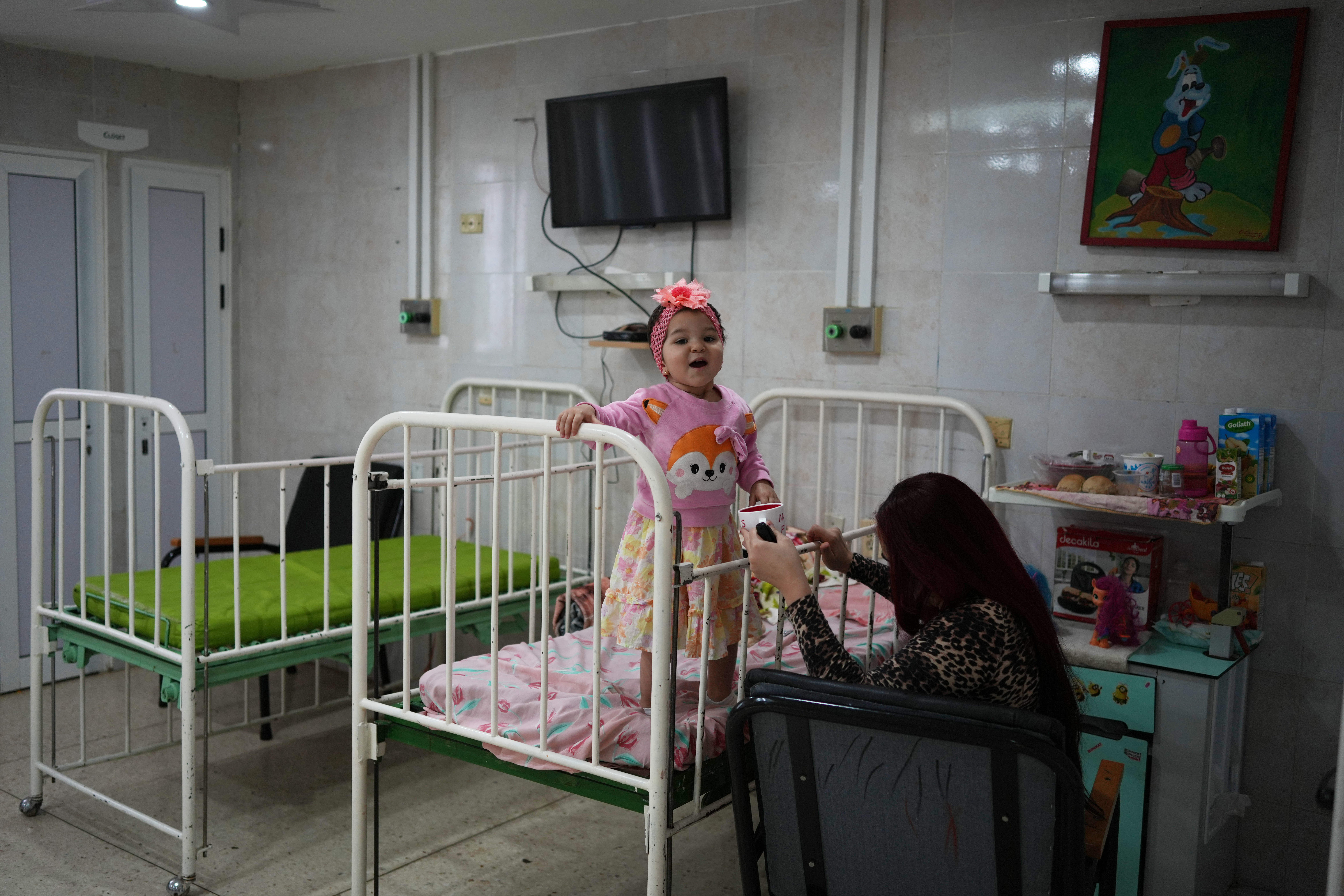 A patient stands on her bead at an oncology hospital in Havana, Cuba, Saturday, March 28, 2026, during a visit by members of the World Council of Churches. (AP Photo/Ramon Espinosa)