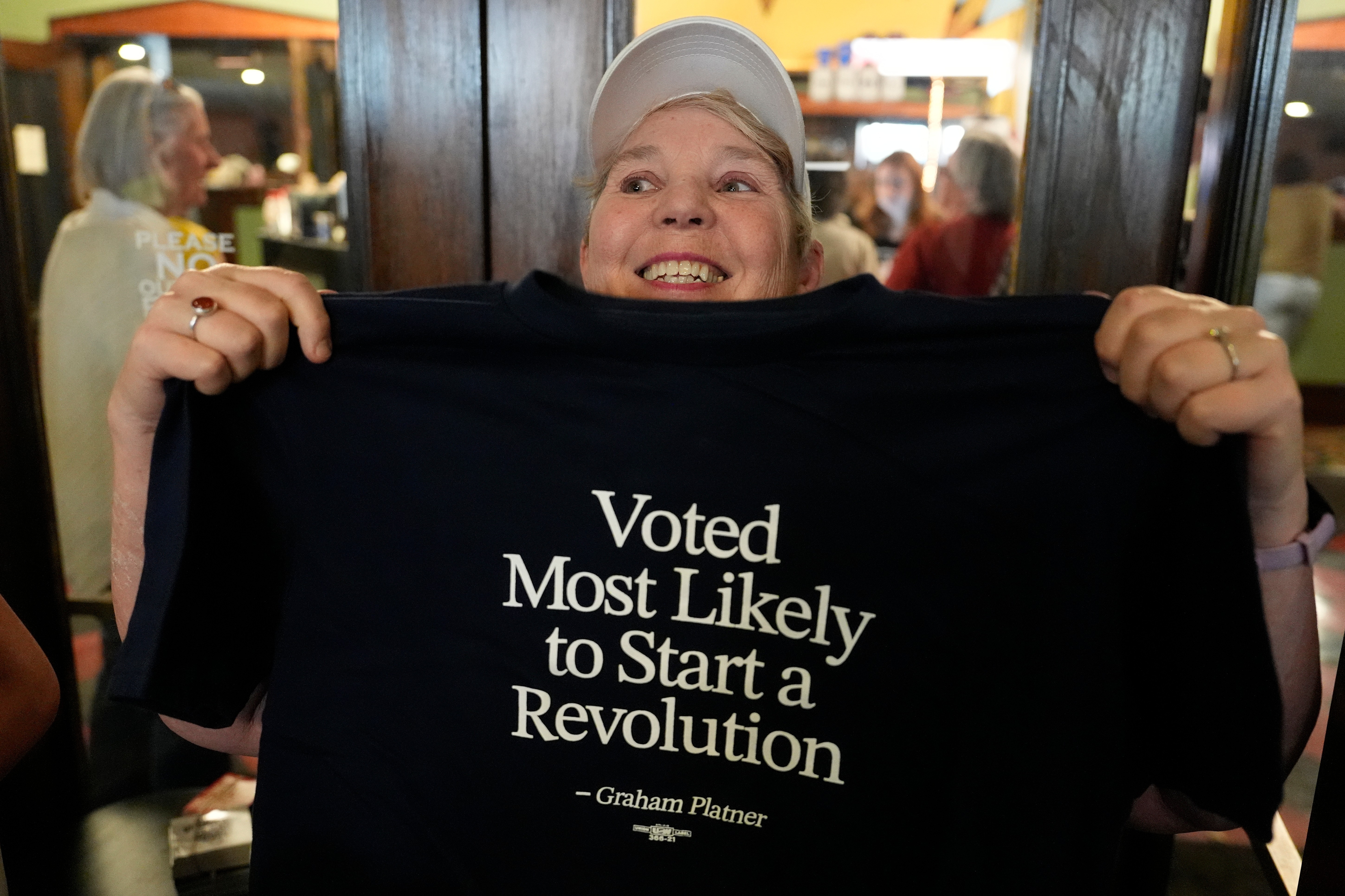 Jodi Edwards, a campaign volunteer for Graham Platner, Democratic candidate for US Senate, shows off a t-shirt at a rally Friday, June 5, 2026, in Bar Harbor, Maine