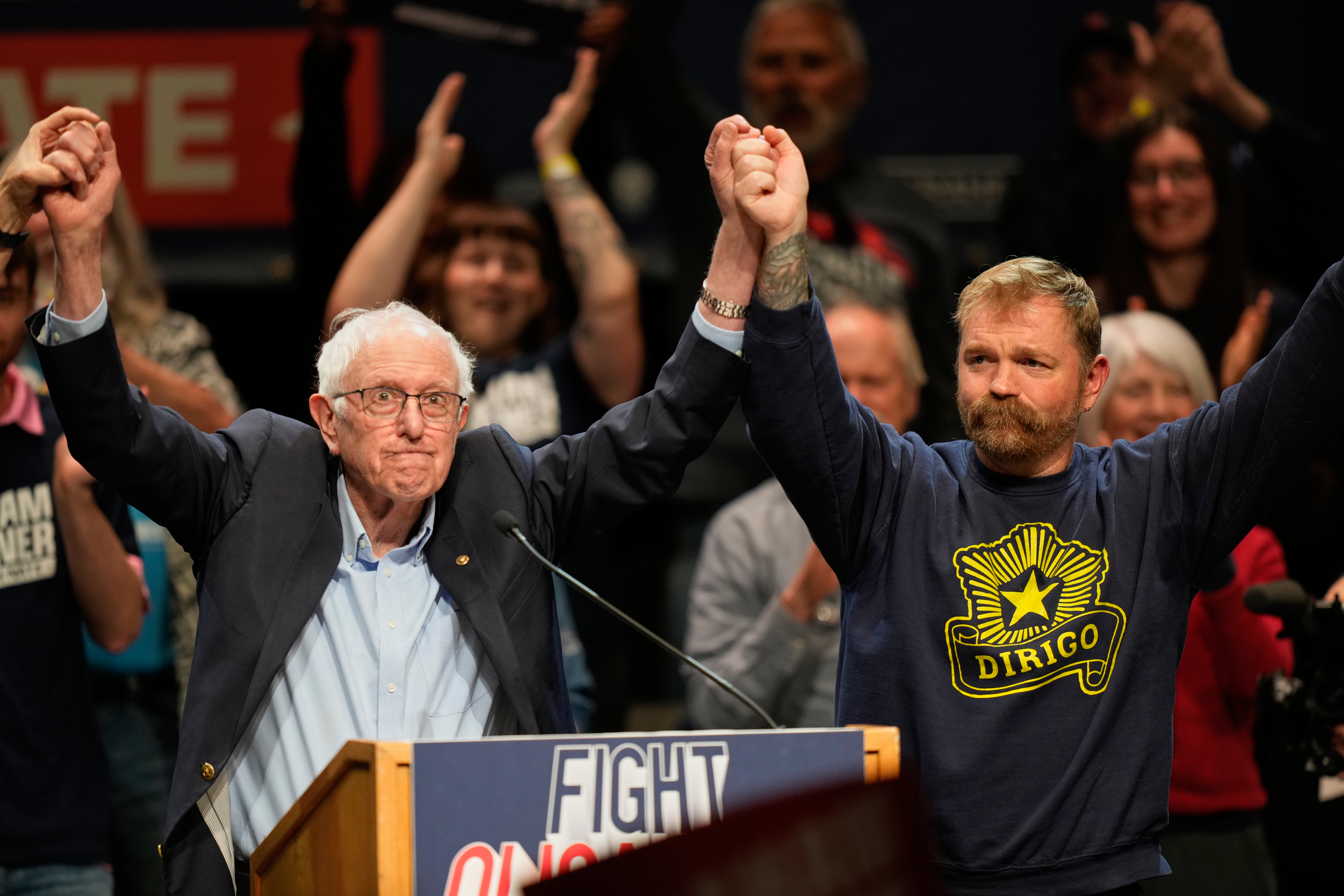 Graham Platner, Democratic candidate for US Senate, and Senator Bernie Sanders, left, join hands at an event in Orono, Maine, May 24, 2026