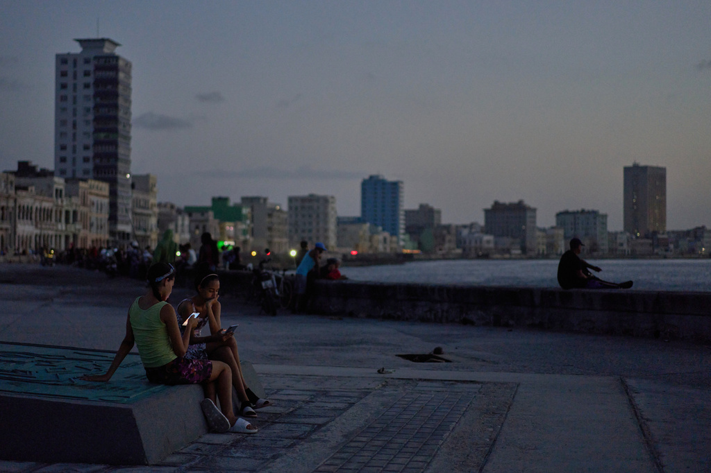 People sit by the beach