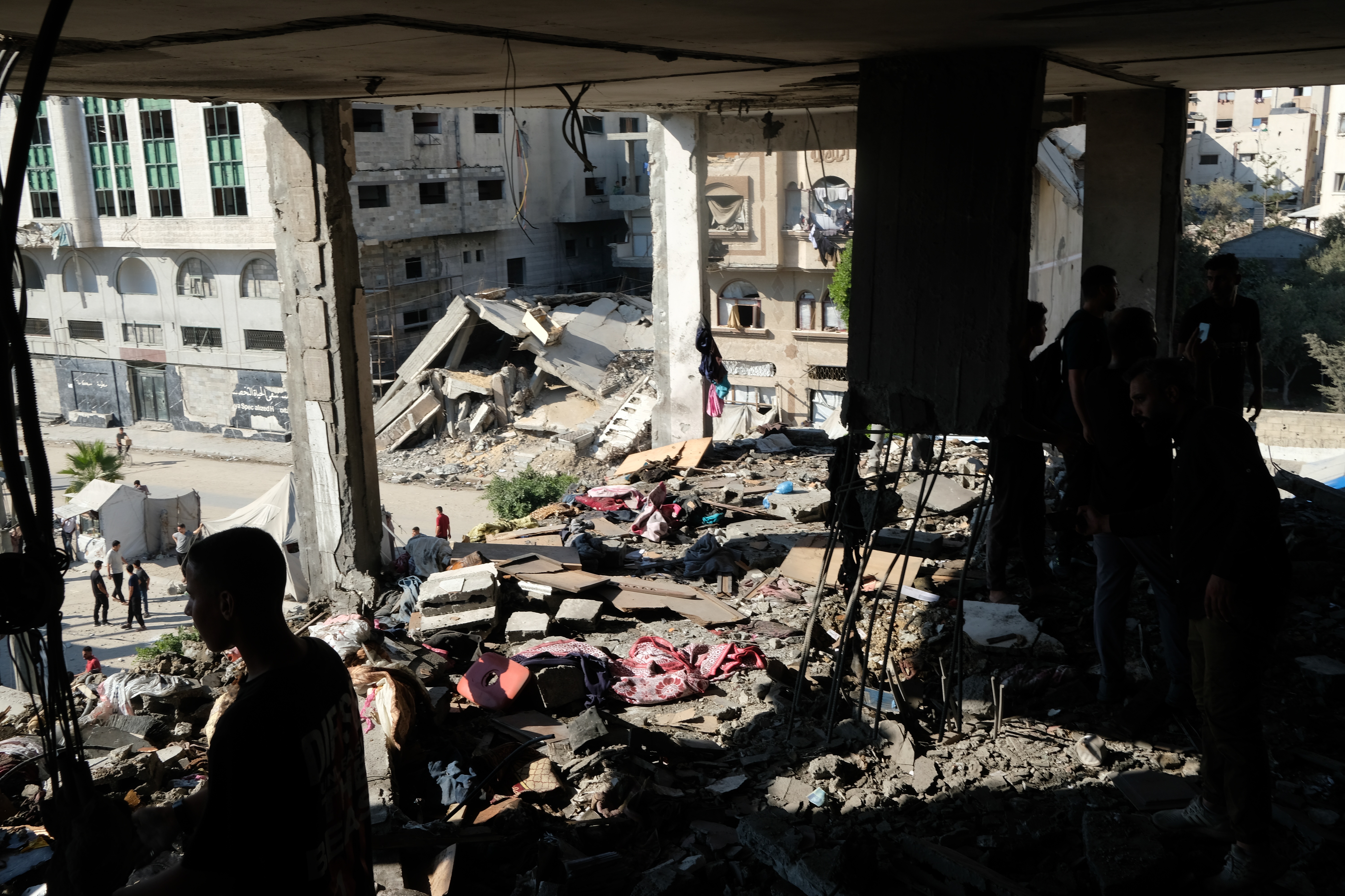 Residents inspect the site of an Israeli airstrike in Gaza city, Saturday, July 18, 2026. (AP Photo/Jehad Alshrafi)