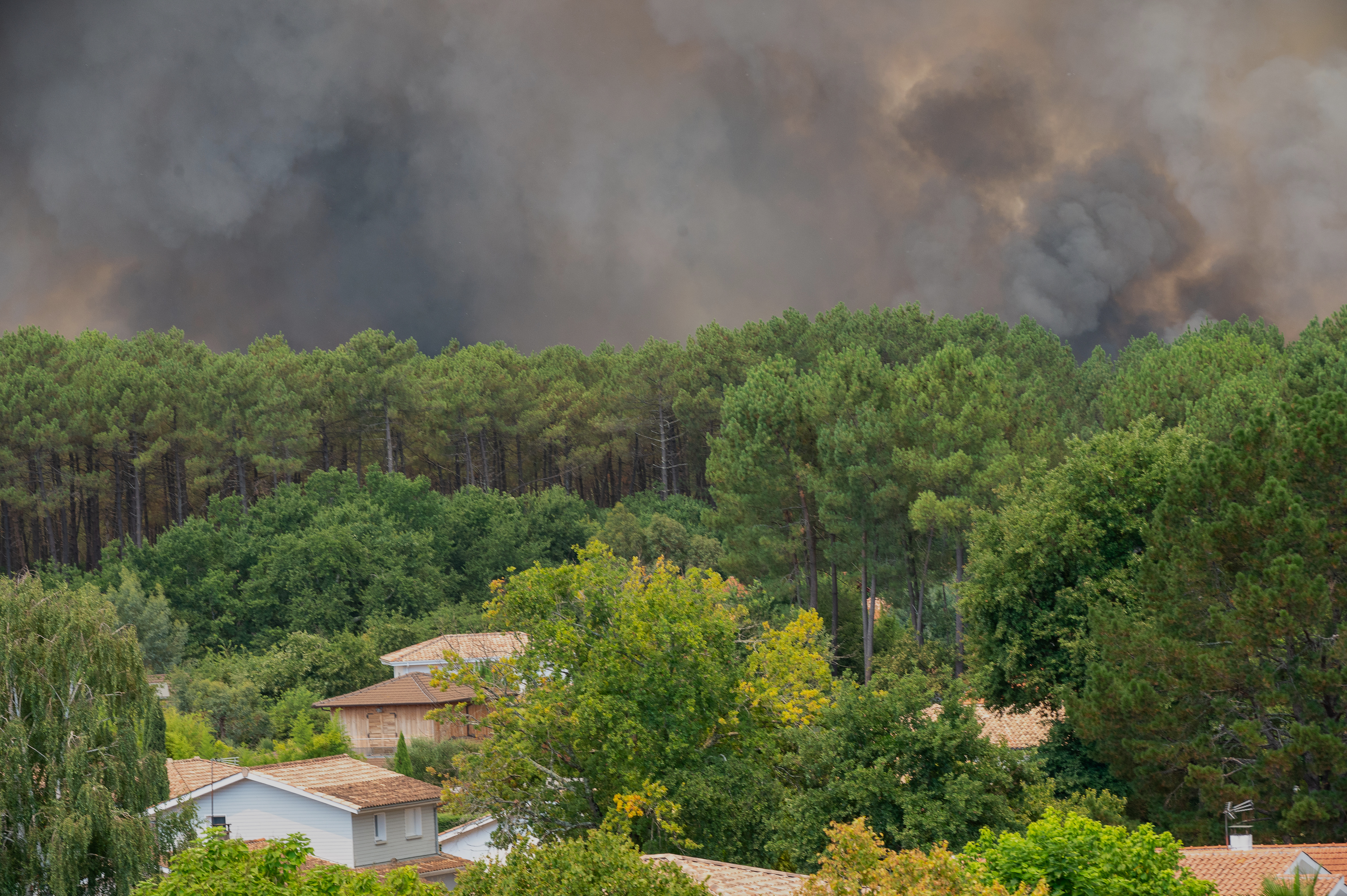 Smoke rises over wildfires in the Lège-Cap-Ferret region, western France on July 23, 2026.