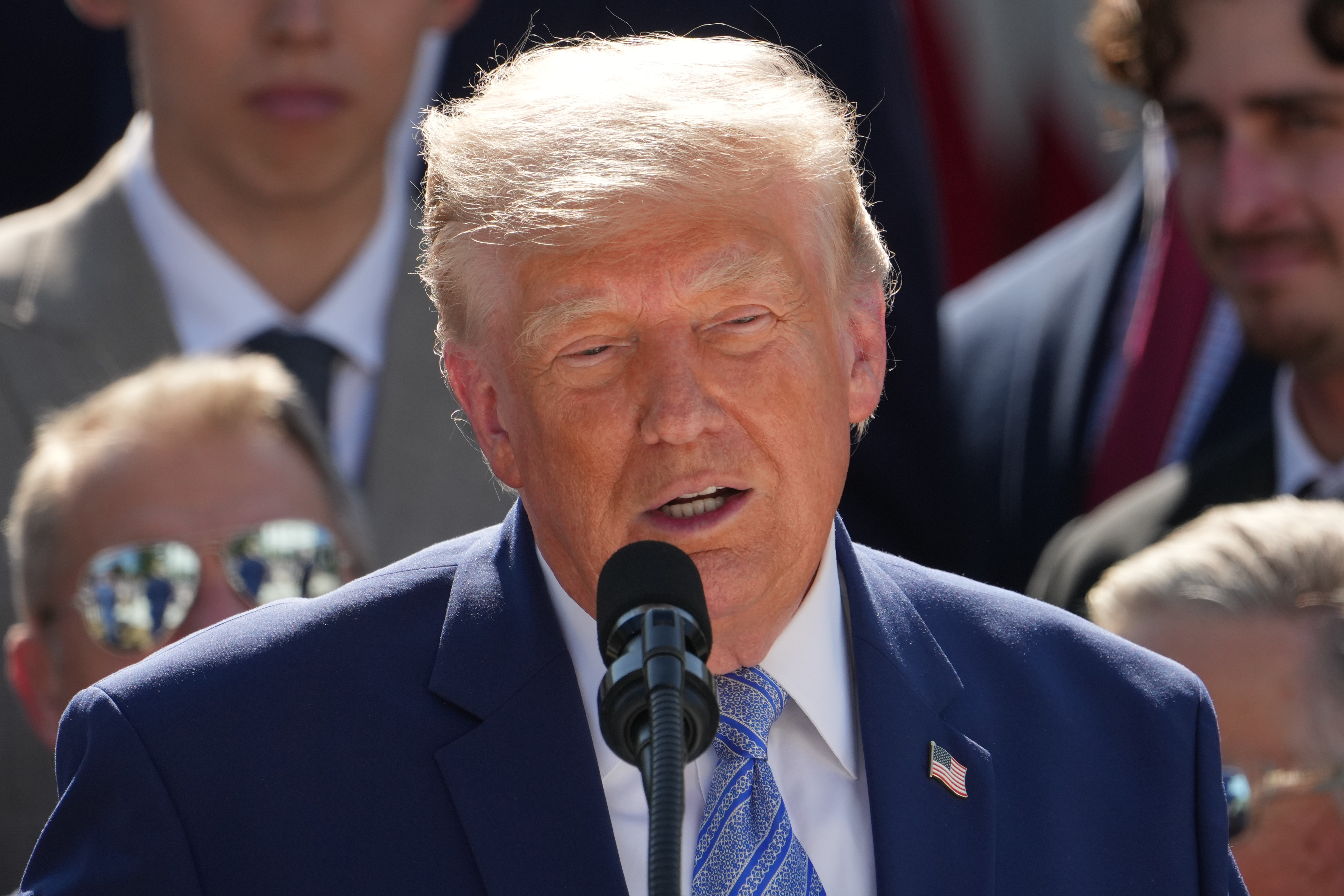 A man stands at a microphone