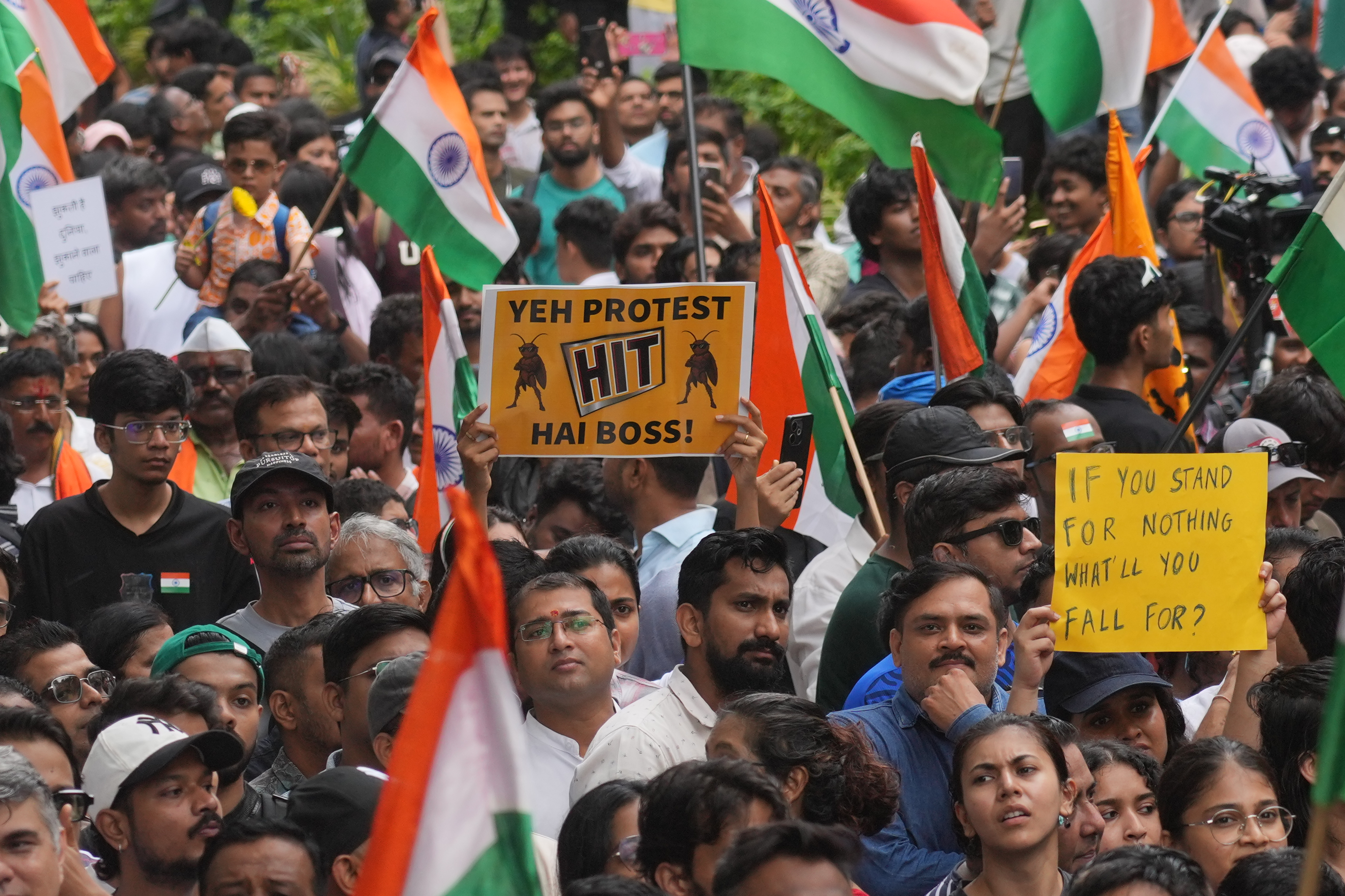 Protesters celebrate after Education Minister Dharmendra Pradhan resigned, in Mumbai, July 26, 2026