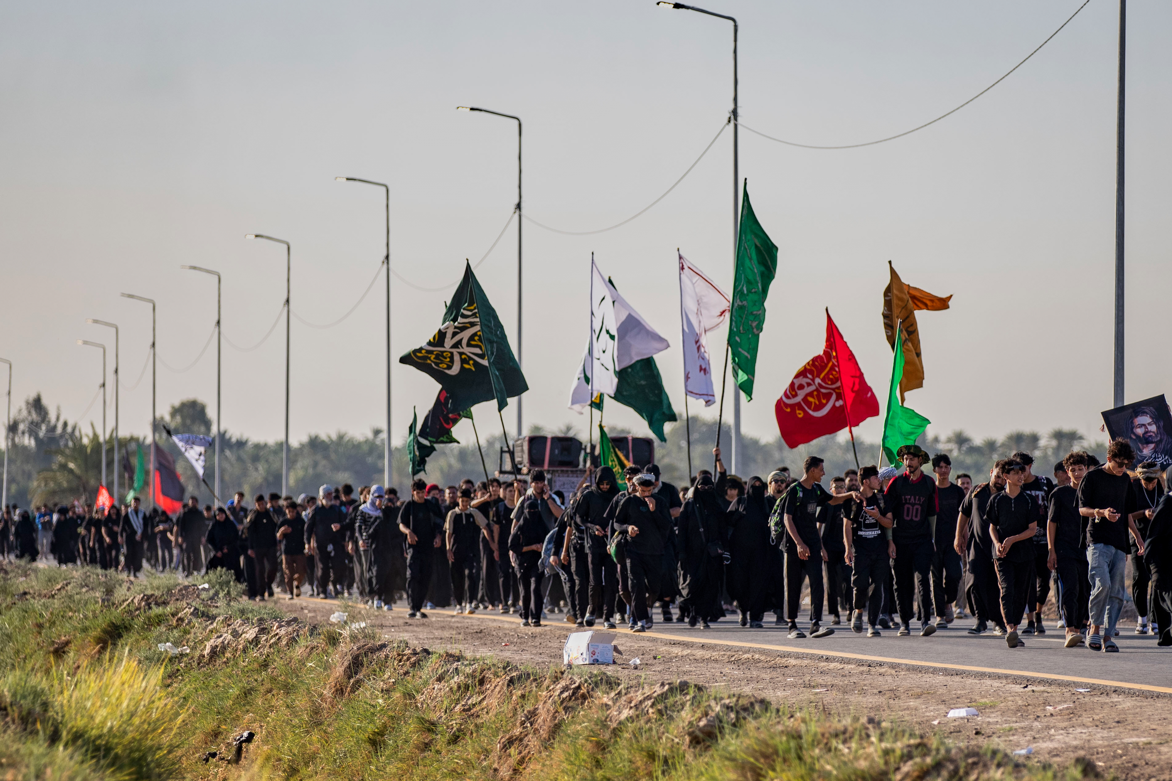 Shiite pilgrims march to Karbala, to observe Arbaeen that marks the end of a 40-day mourning period following the Day of Ashura, in Najaf, Iraq [Anmar Khalil/AP]