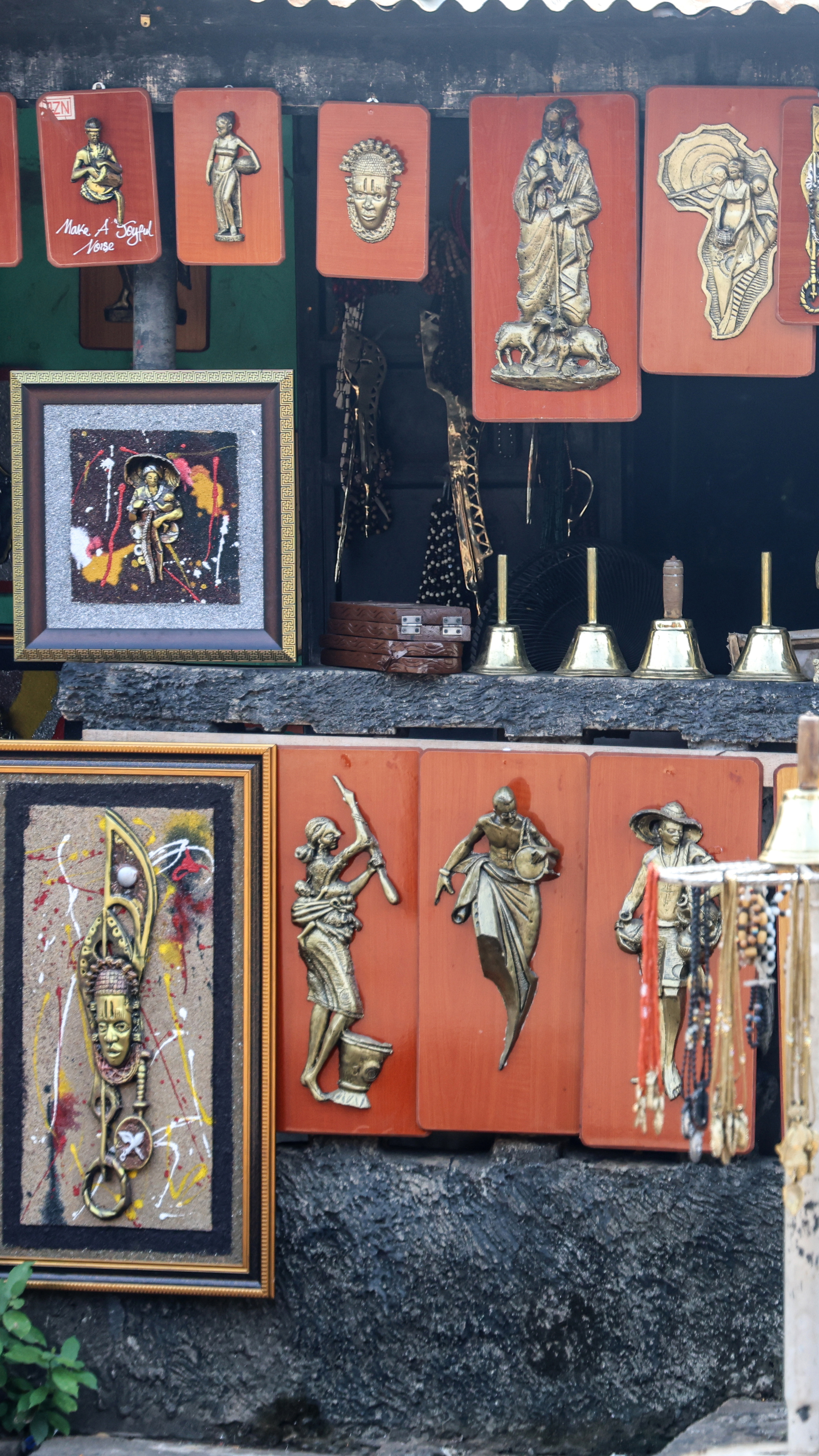 Art and sculptures are displayed outside a shop on Igun Street