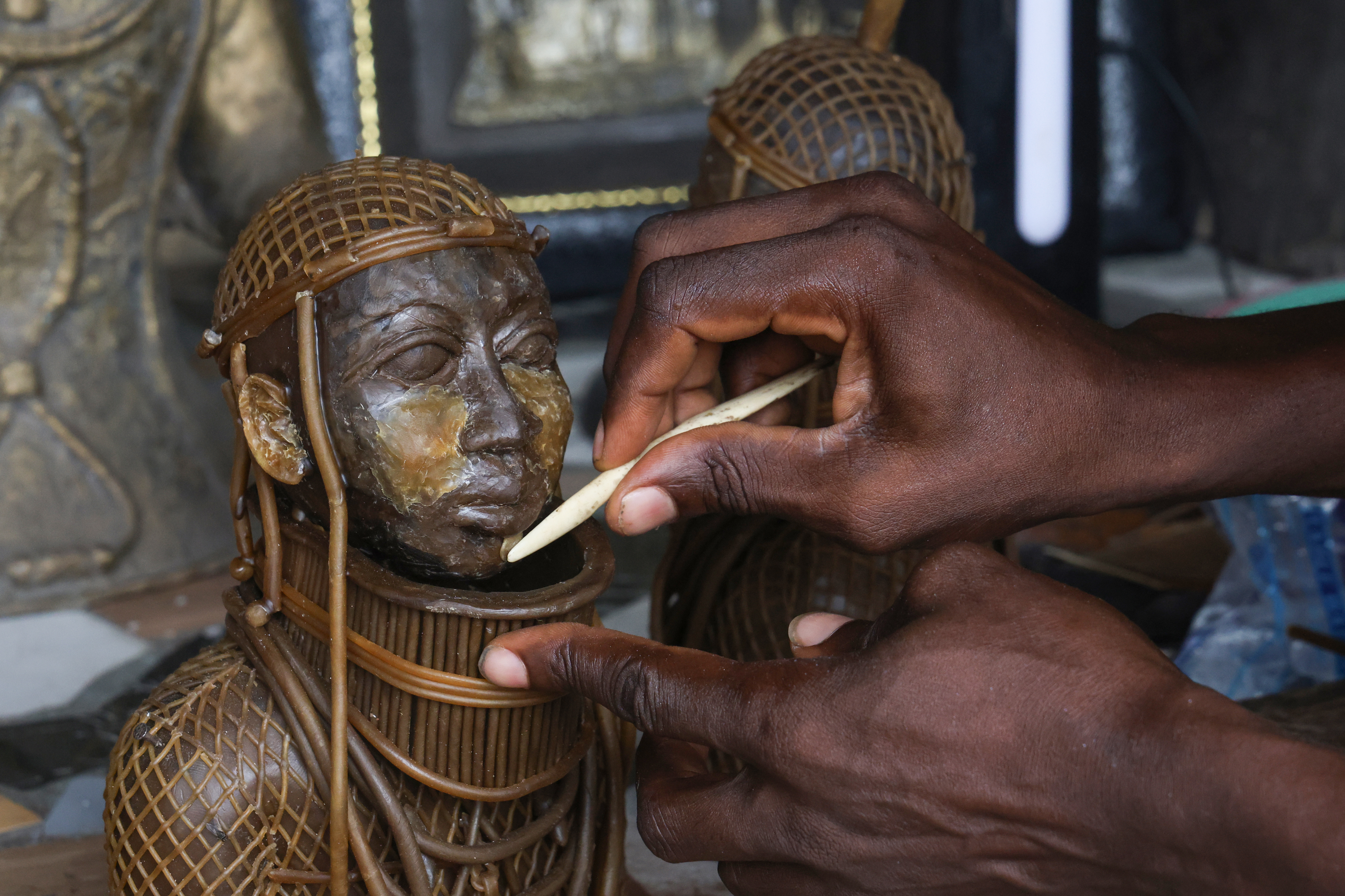 Precision defines the final stages of bronze casting, where the smallest facial details are shaped by hand