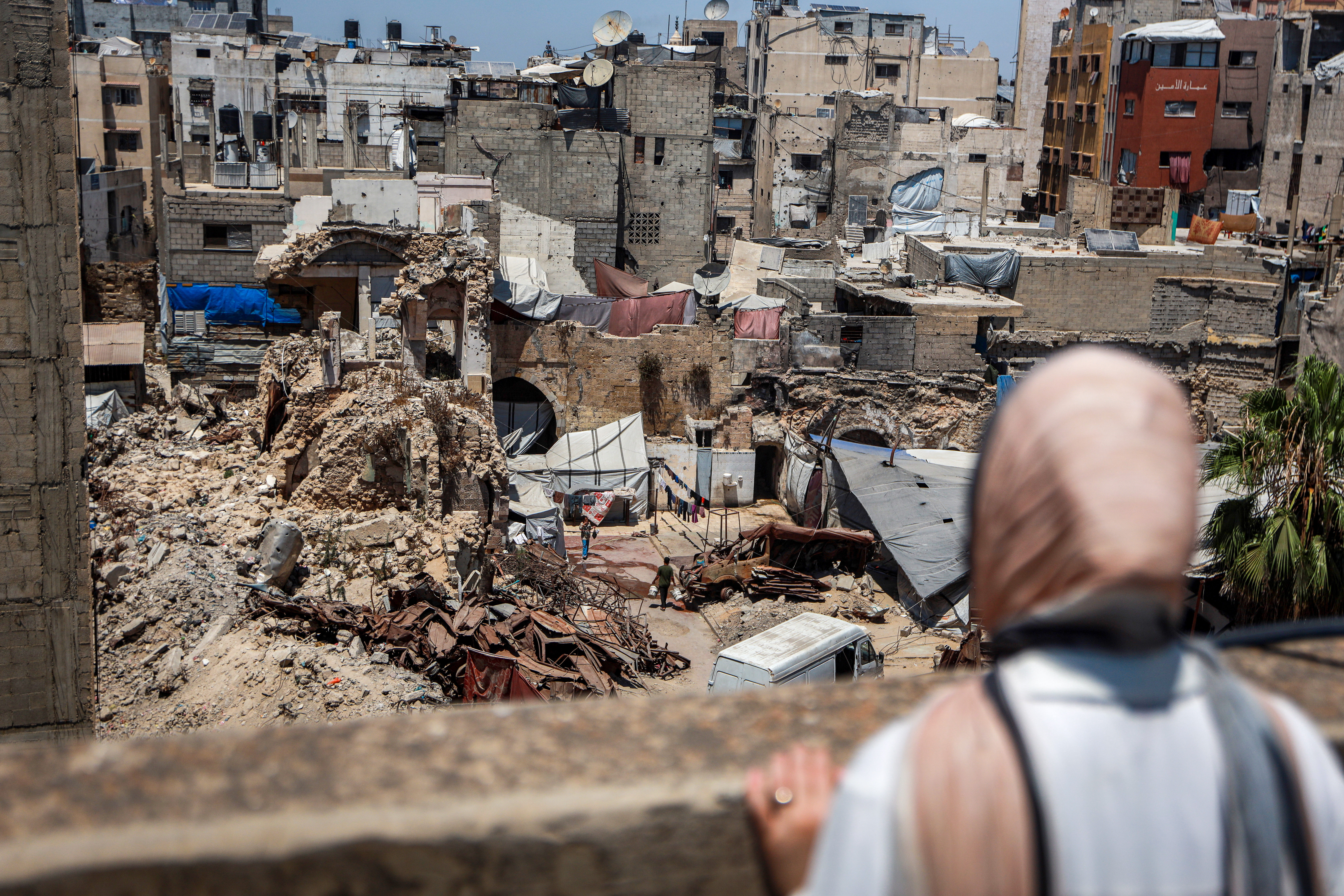 Eman Lulu stands overlooking the destruction of Gaza City