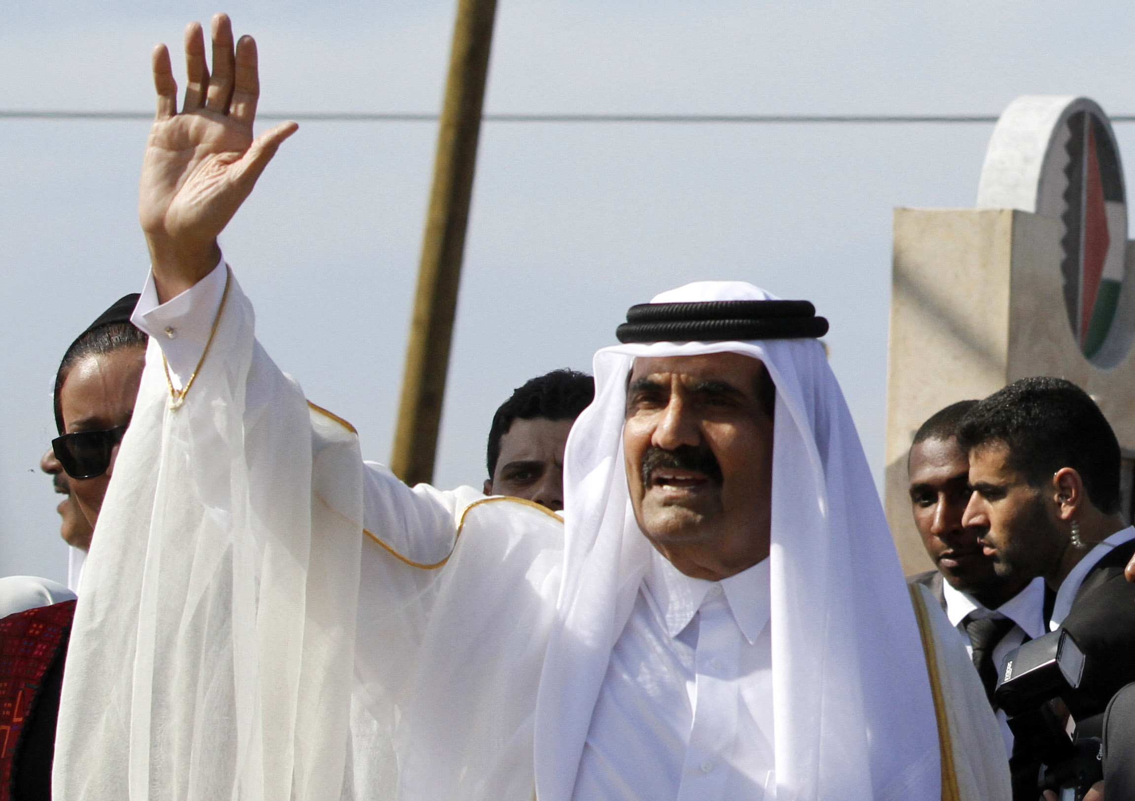 Sheikh Hamad bin Khalifa Al Thani waves to the crowd as he arrives at a cornerstone-laying ceremony for a Qatari-funded rehabilitation centre in Gaza City on October 23, 2012