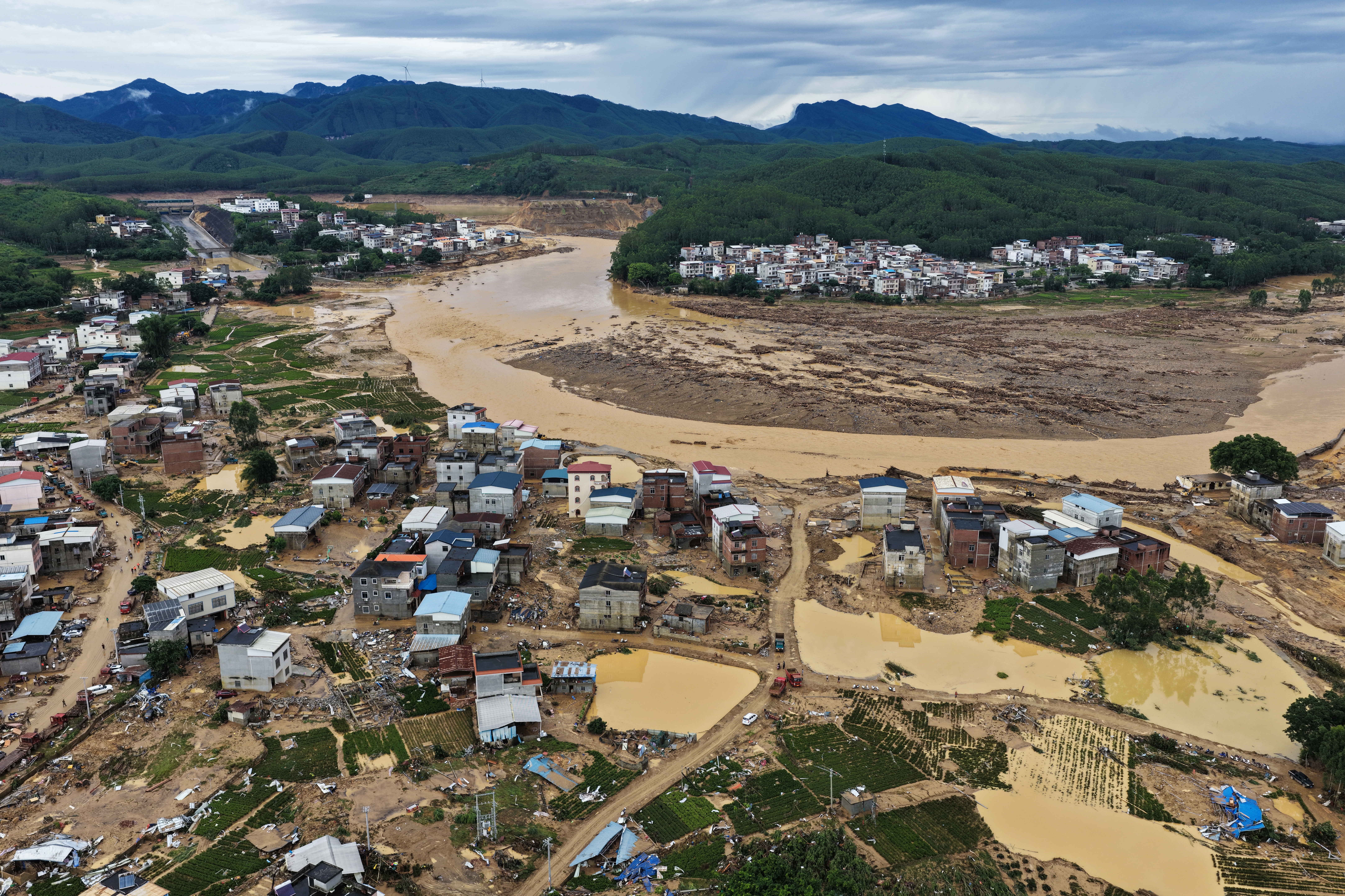 Floodwaters rush from a breach in the Liulan Reservoir dam following heavy rainfall brought by Typhoon Maysak on July 7, 2026 in Hengzhou, Nanning, Guangxi Zhuang Autonomous Region of China