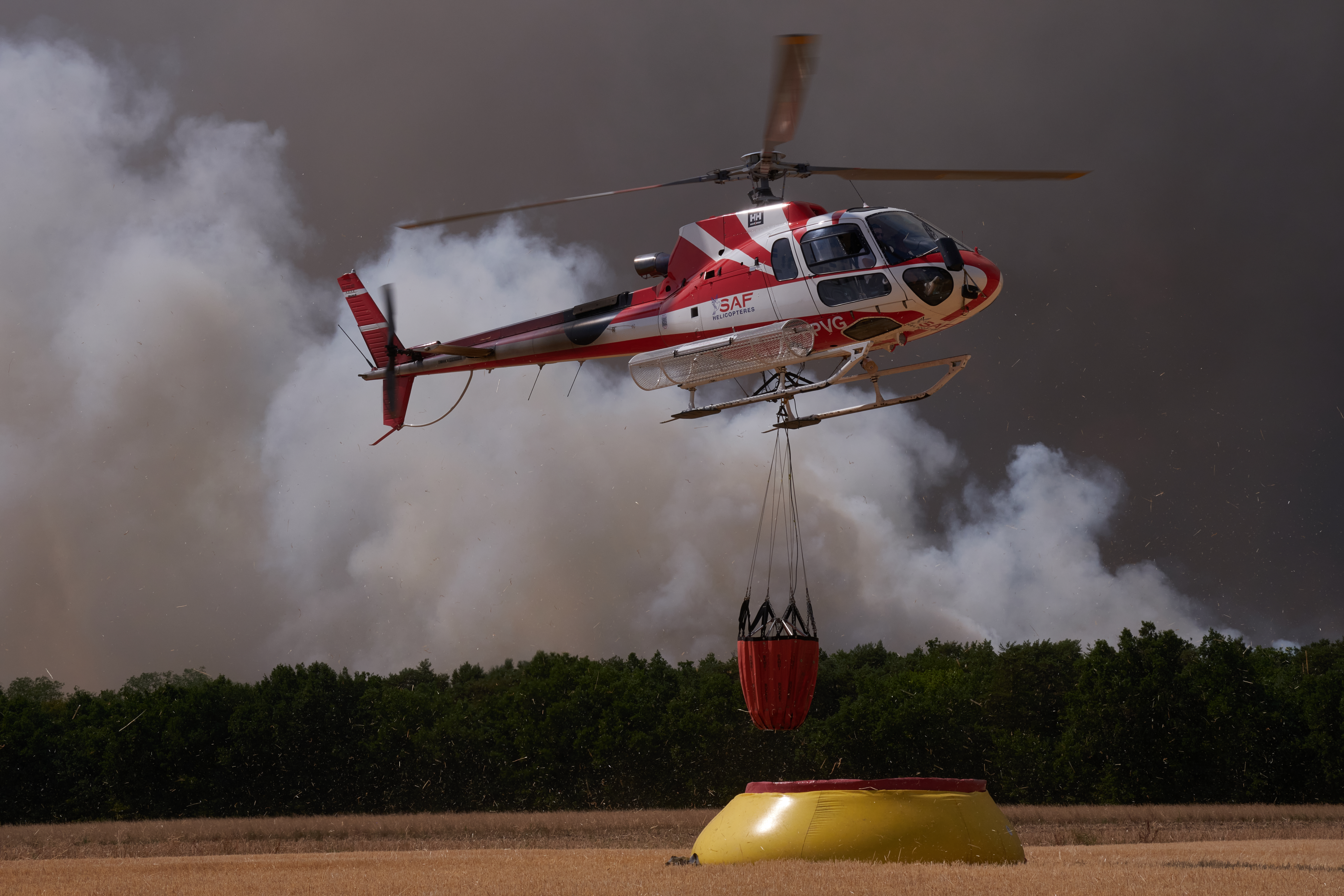 firefighters works to extinguish flames in the Fontainebleau forest