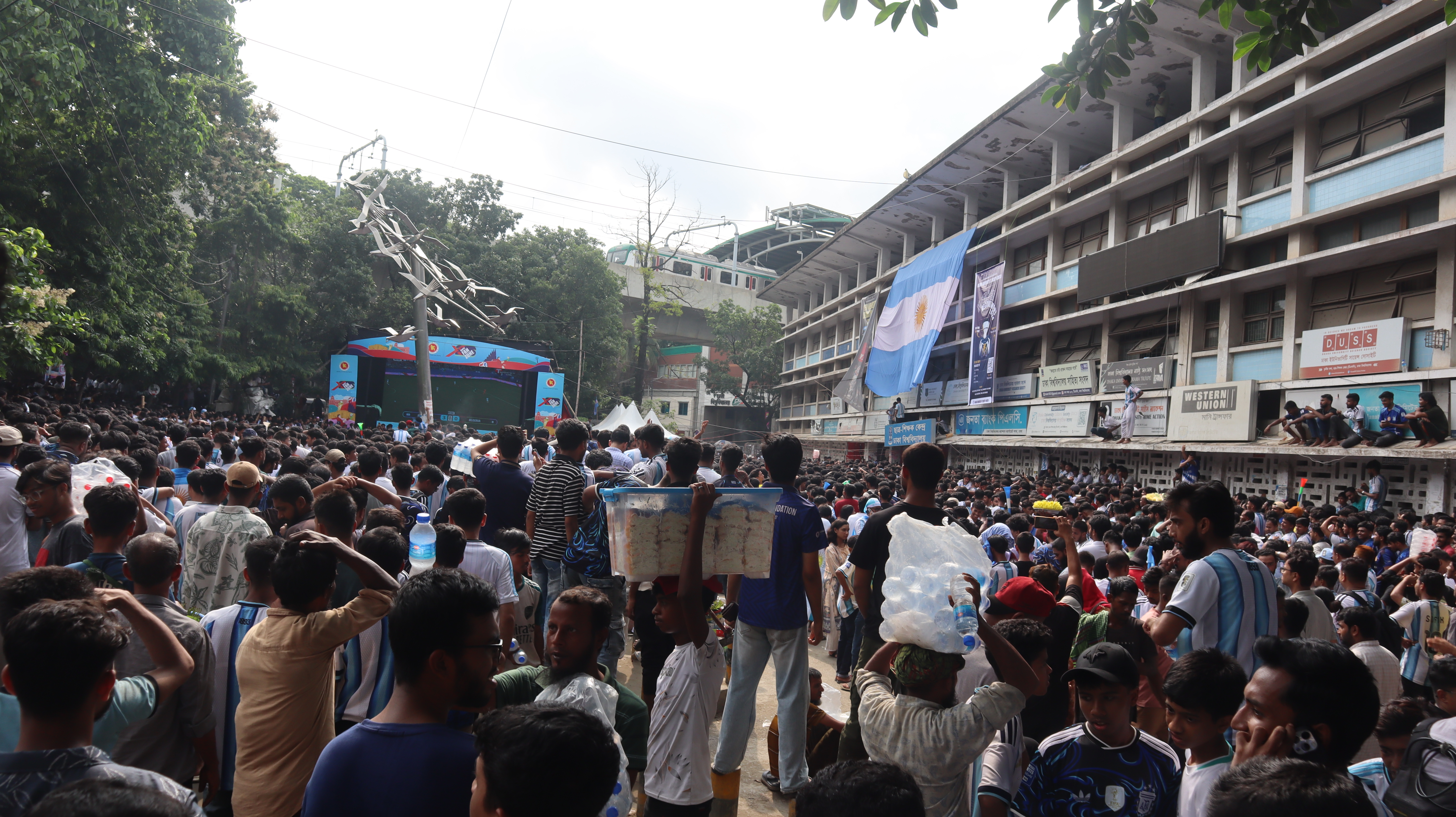 Thousands of Bangladeshi fans gathered before a giant screen at Dhaka University for the Argentina-Algeria match on June 17, 2026 [Masum Billah/ Al Jazeera]