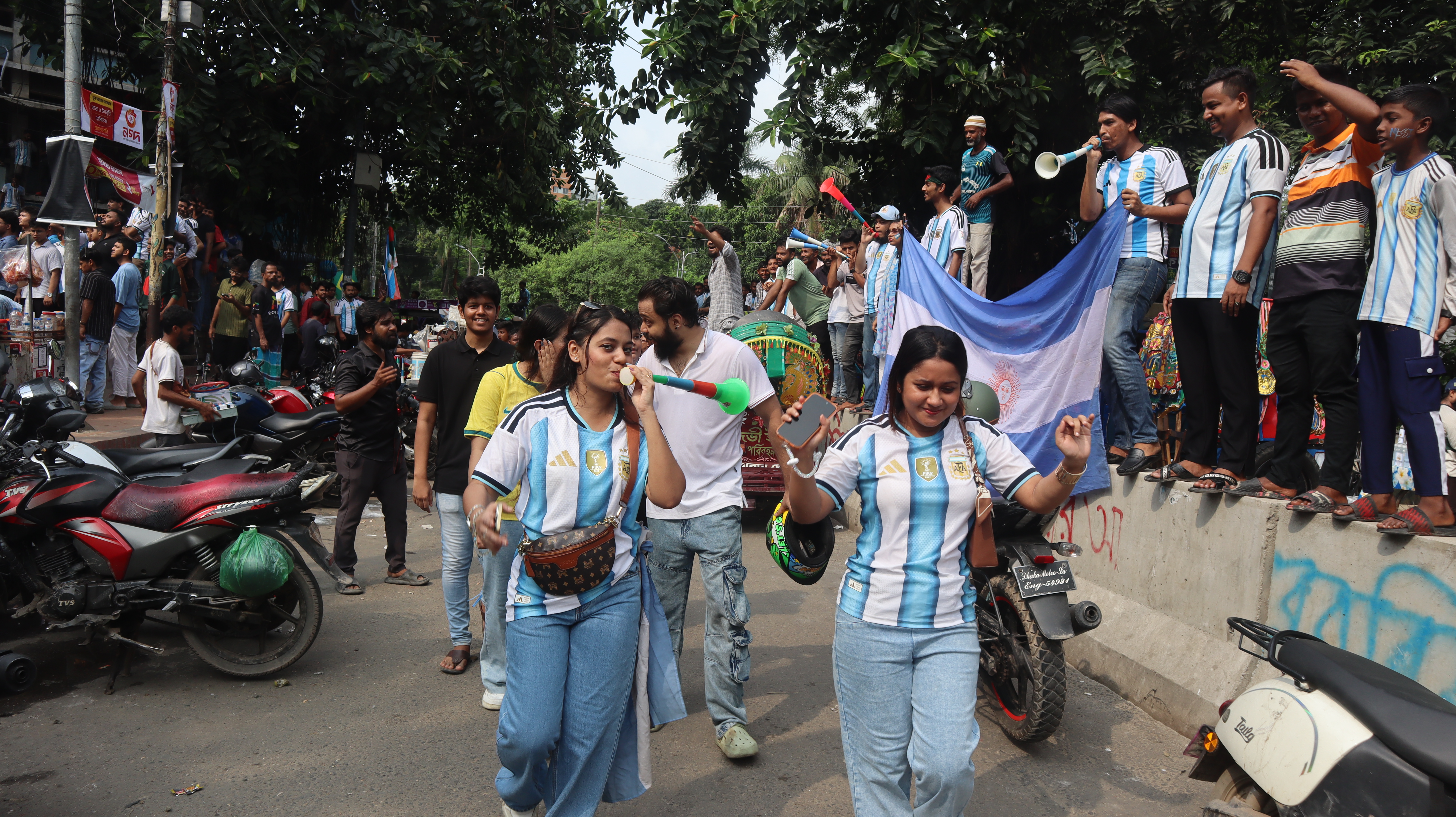 Bangladeshi fans blow on vuvuzelas ahead of Argentina's match against Algeria on June 17, 2026 [ Masum Billah/ Al Jazeera]