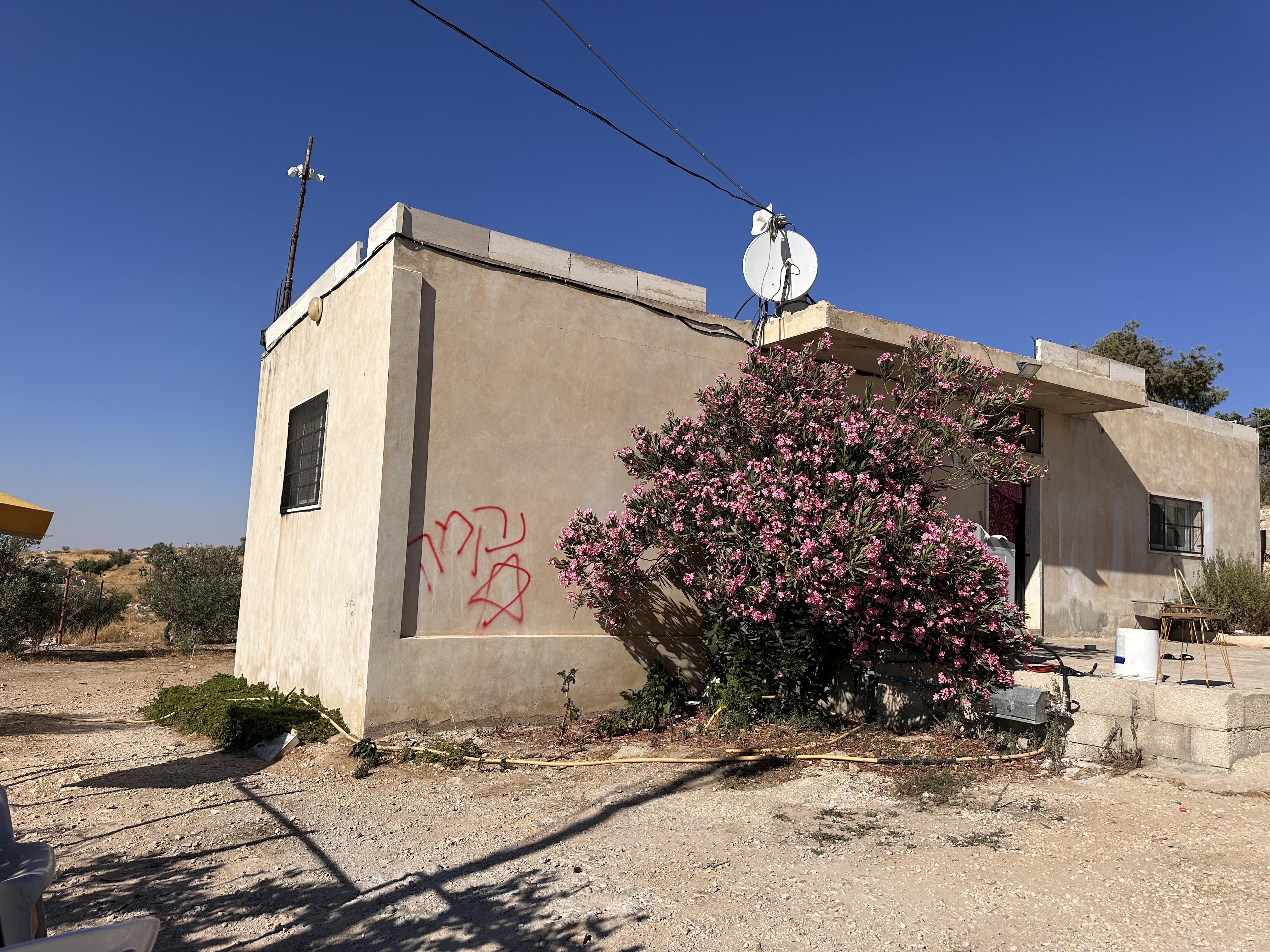 Hebrew graffiti reading ‘revenge’ sprayed on the wall of a Palestinian home in at-Tuwani during an arson attack by Israeli settlers in the early hours of July 19