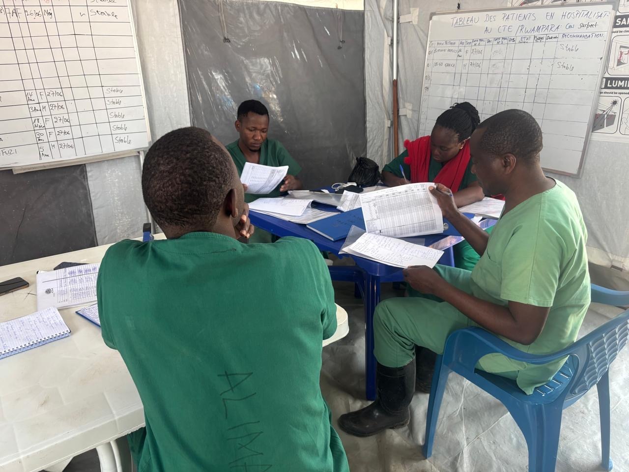 Health workers review patient records at the Rwampara Ebola treatment centre near Bunia, where staff say at least one person is dying from the virus every day.