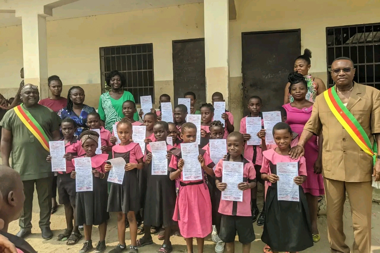 School children receiving birth certificates in Tiko, Cameroon