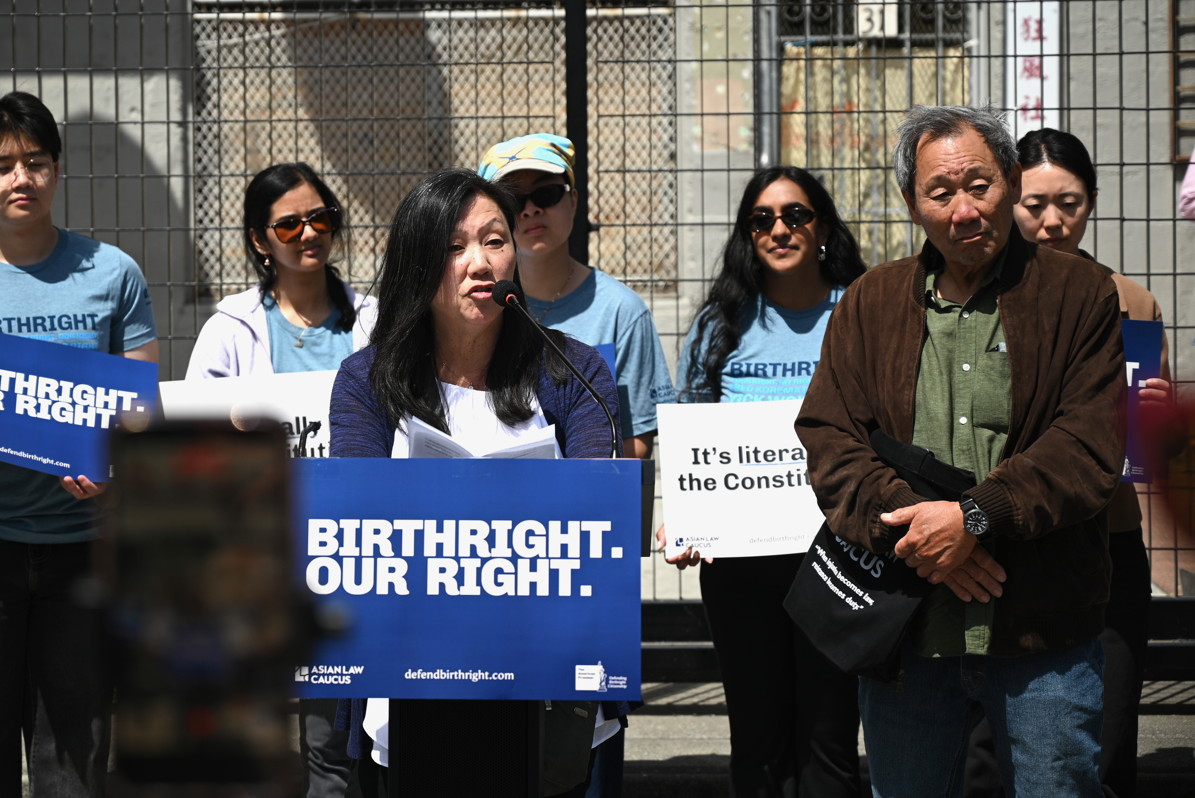 Sandra Wong speaks next to brother Norman