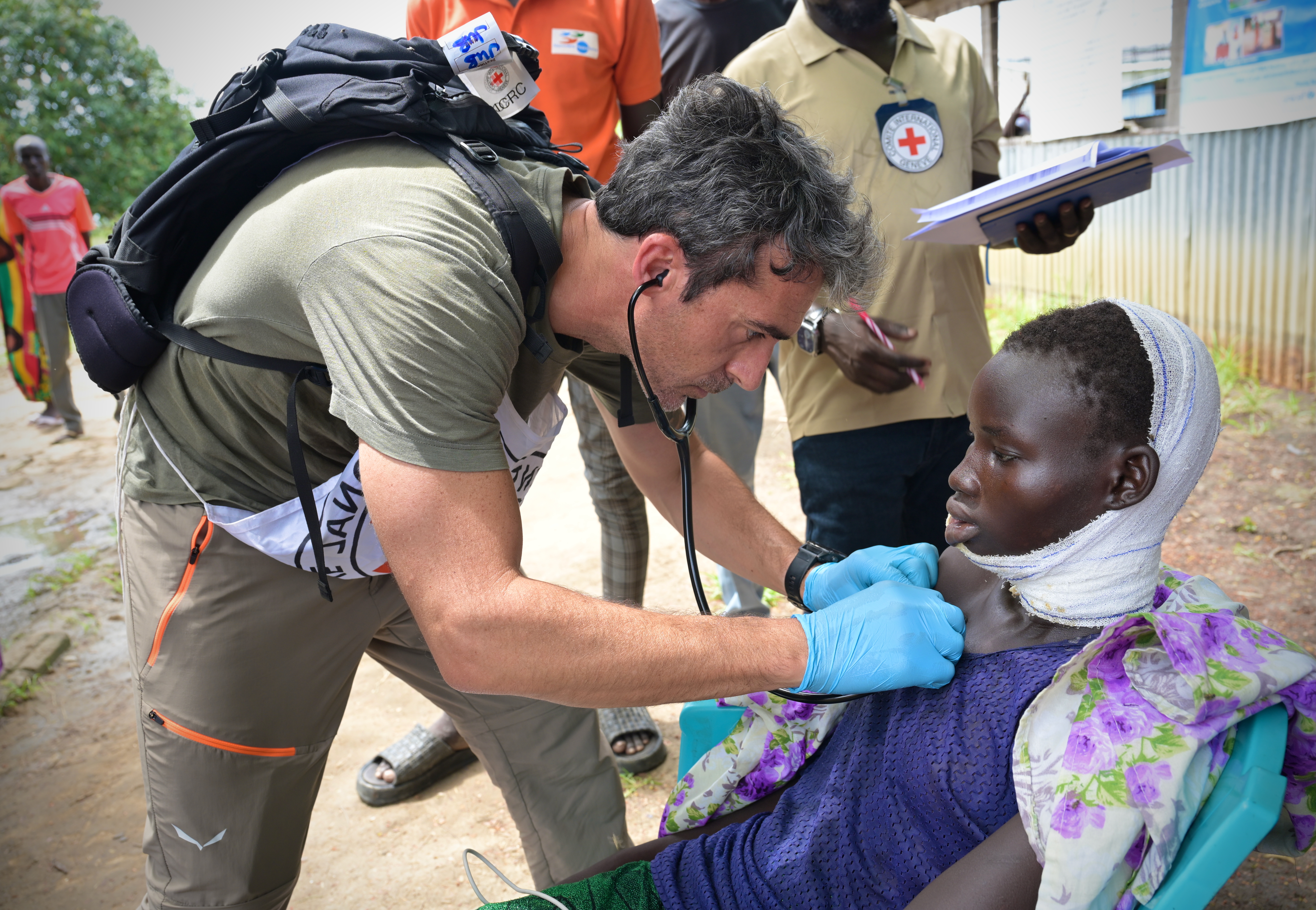 A nurse from the International Committee of the Red Cross (ICRC) tends to a young victim of gunshot wounds at Ganyiel Primary Healthcare Facility in Ganyiel, South Sudan