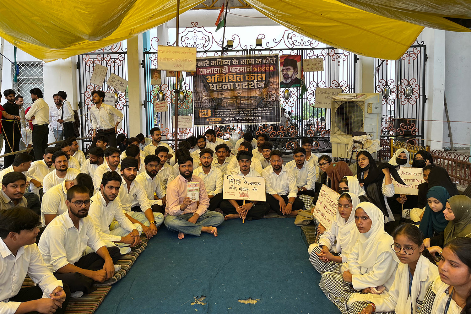 Protesters hold an indefinite sit-in outside the gate of Mohammad Ali Jauhar University in Rampur, Uttar Pradesh, India