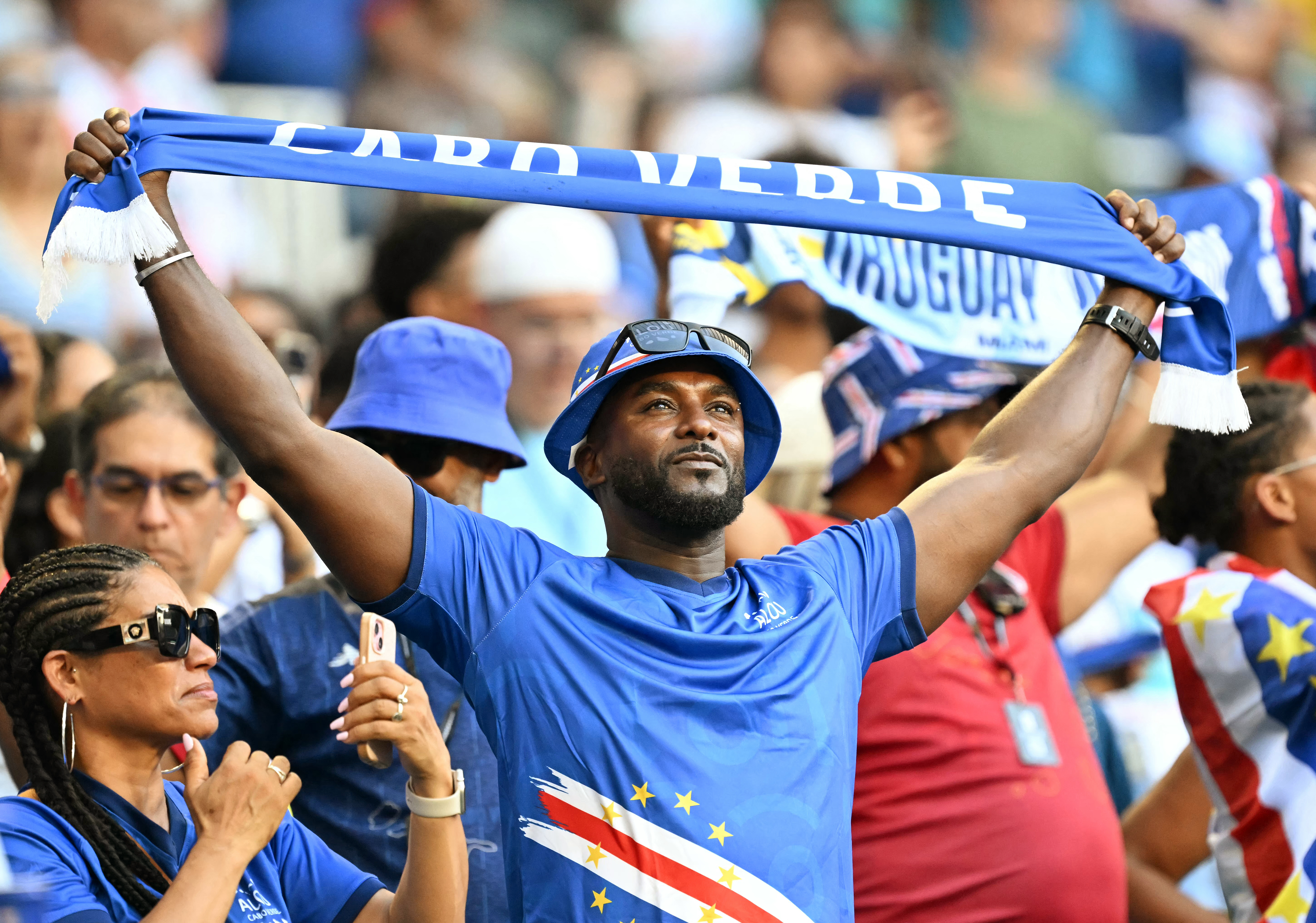 A Cape Verde fan holds a scarf ahead of the 2026 World Cup Group H football match between Uruguay and Cape Verde at the Miami Stadium in Miami Gardens on June 21, 2026.