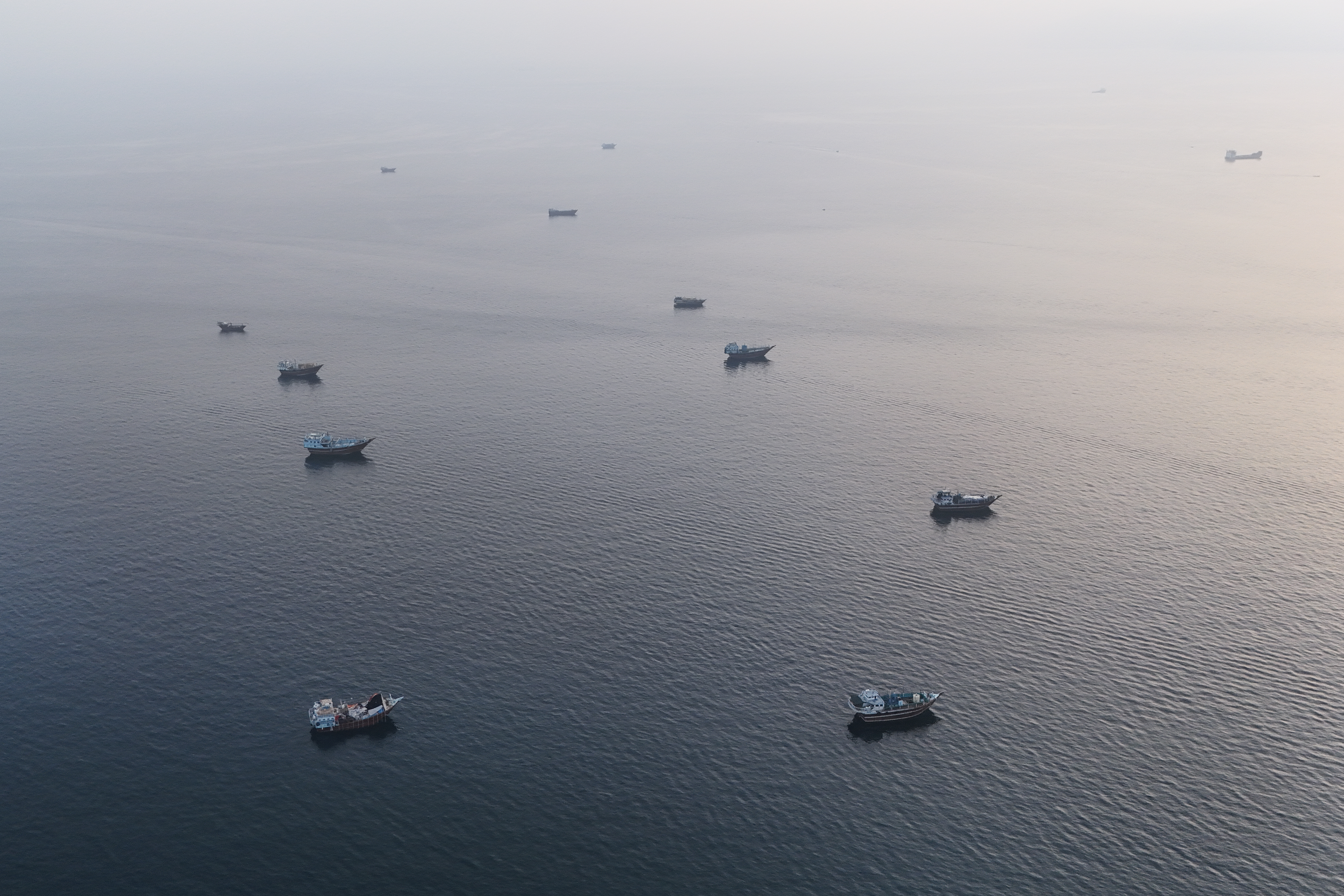 This aerial photograph shows boats anchored off Oman’s northern Musandam Peninsula near the Strait of Hormuz on June 27, 2026.
