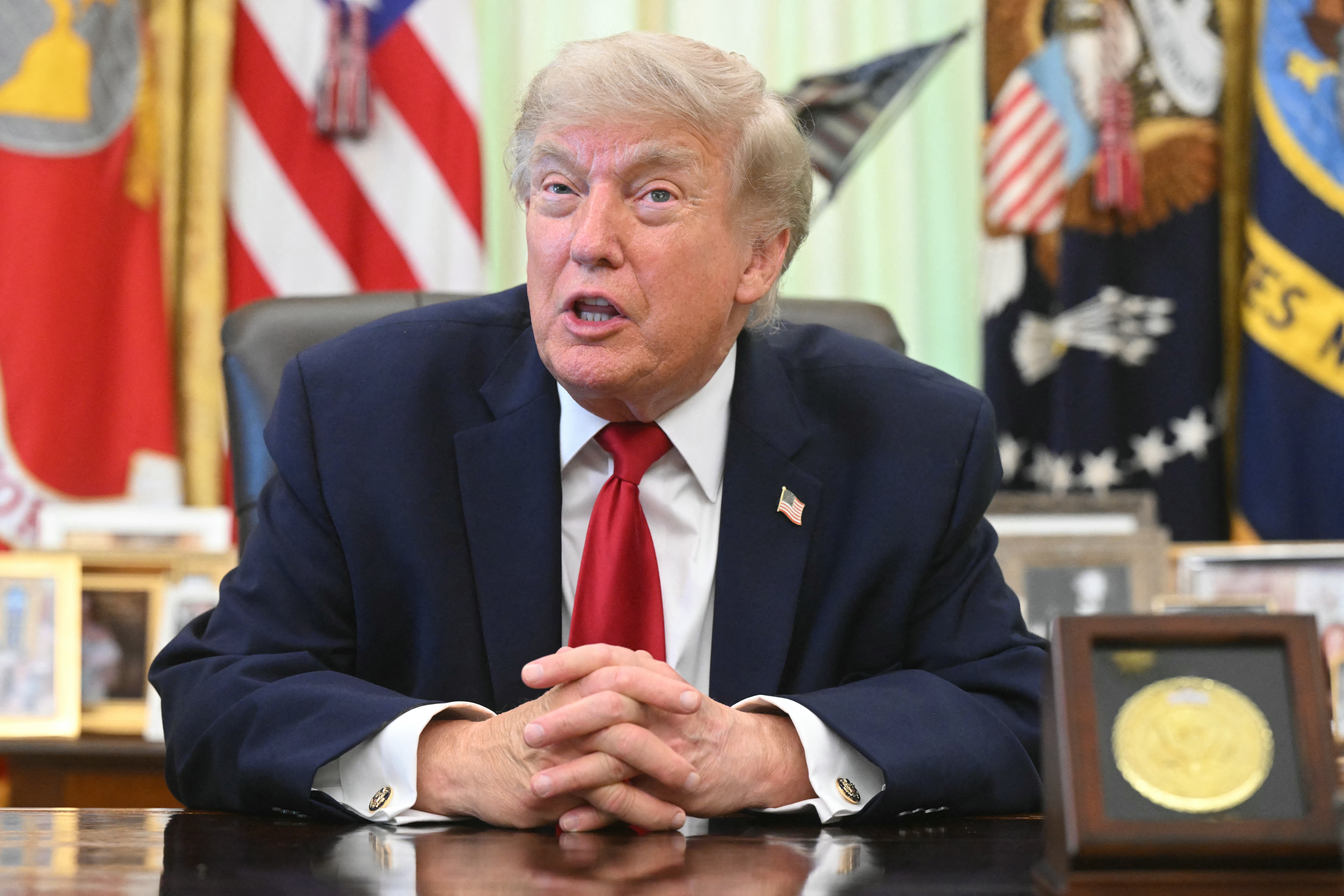 US President Donald Trump speaks with reporters after signing a presidential memo on pollution control in vehicles at the Oval Office of the White House in Washington, DC, on June 29, 2026. (Photo by SAUL LOEB / AFP)