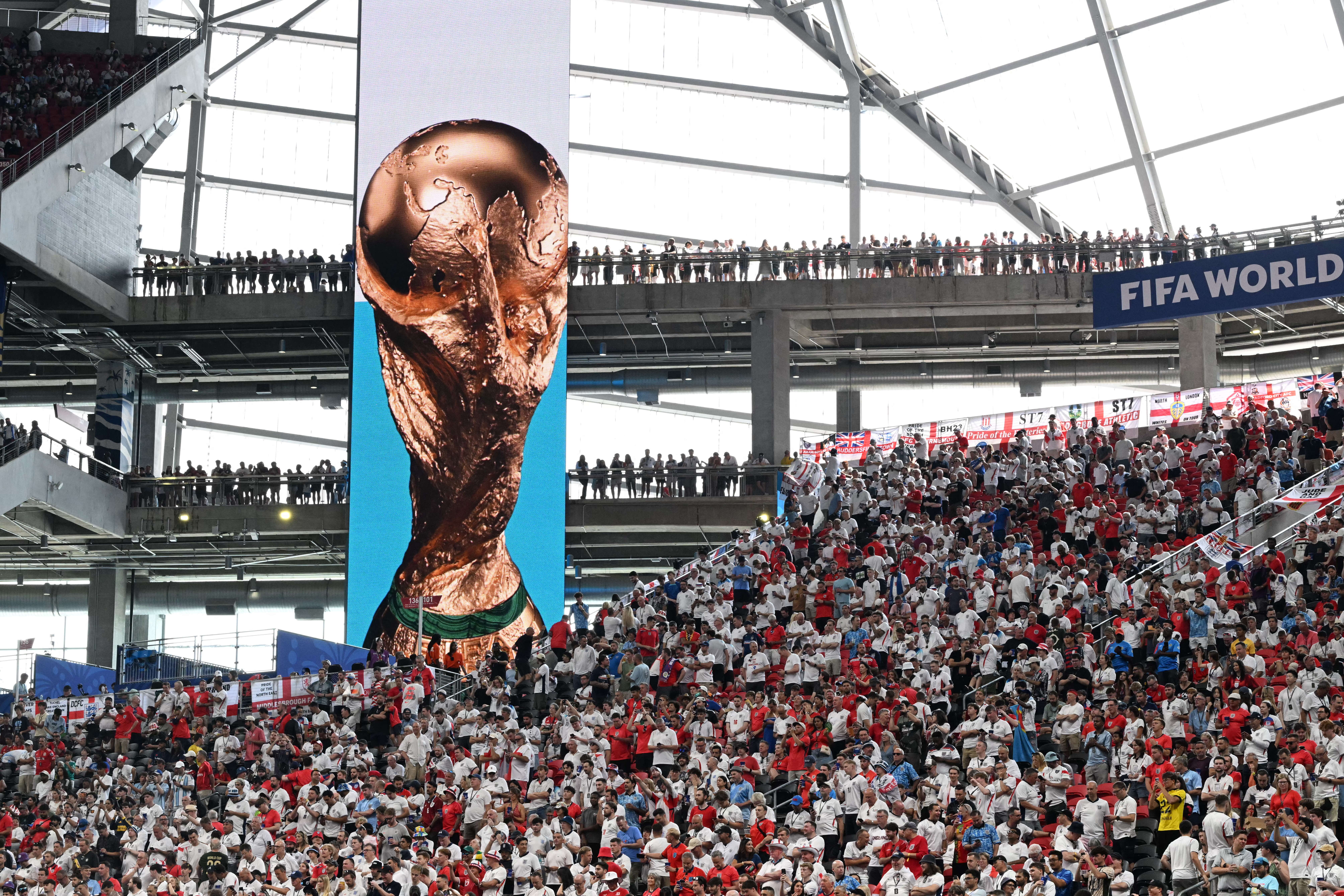 England supporters stand in the tribunes beside a giant screen displayed the trophy ahead of the 2026 World Cup round of 32 match football between England and the Democratic Republic of Congo at the Atlanta Stadium in Atlanta on July 1, 2026.