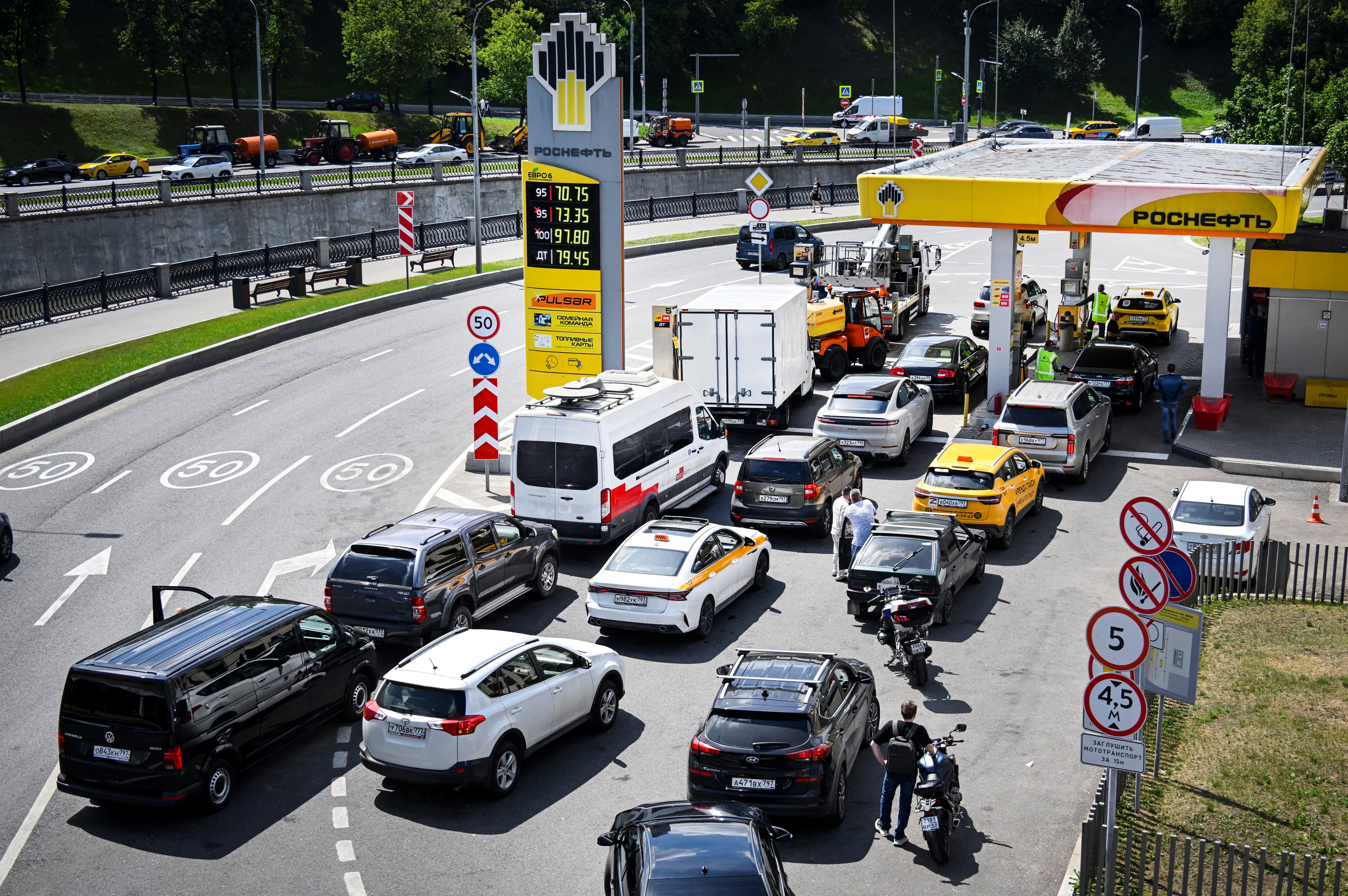 People queue to refuel their cars at a Rosneft gas station in Moscow on June 30, 2026.