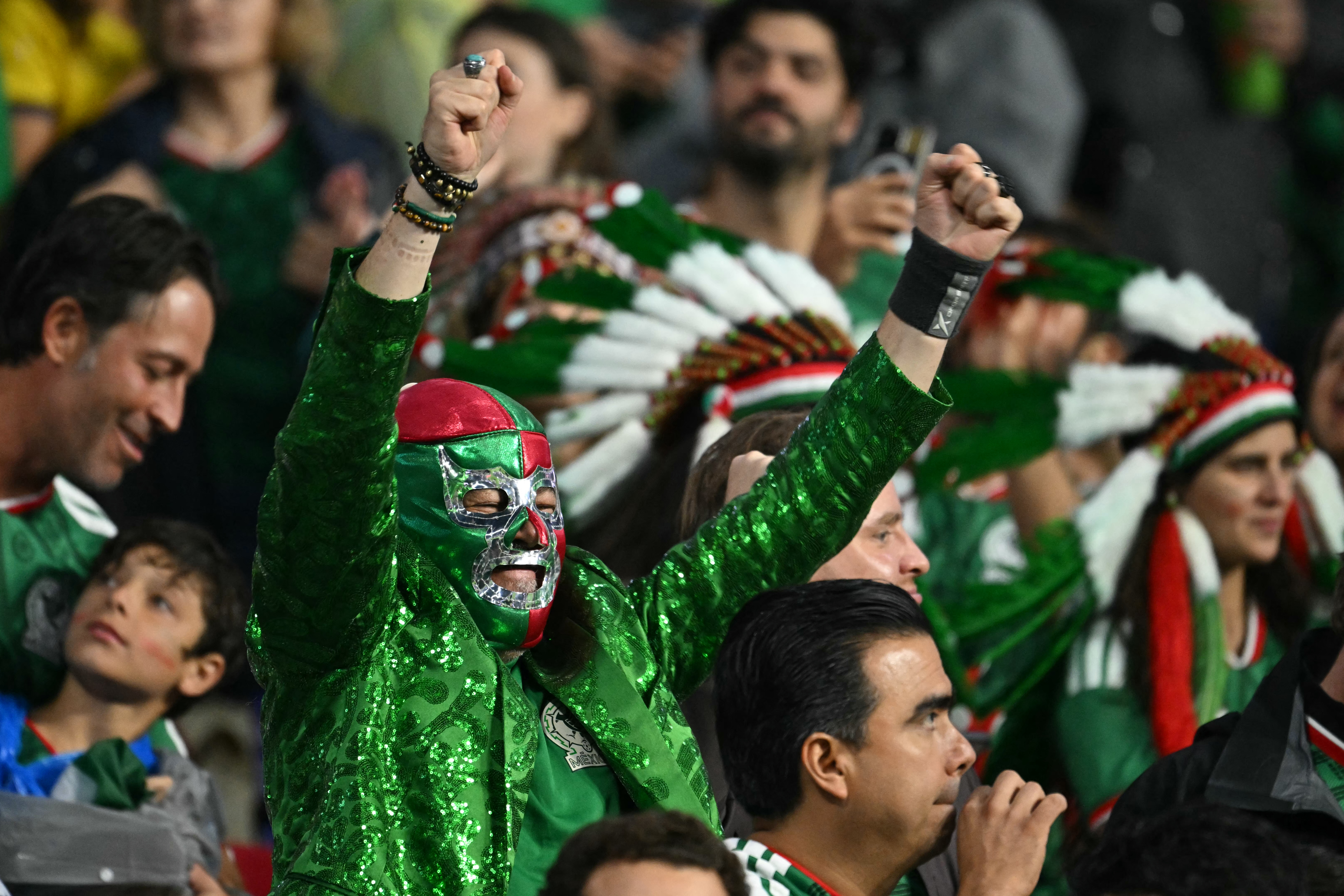 A Mexican fan wearing a lucha libre mask cheers during the 2026 World Cup round of 32 football match between Mexico and Ecuador at the Mexico City Stadium in Mexico City on June 30, 2026.