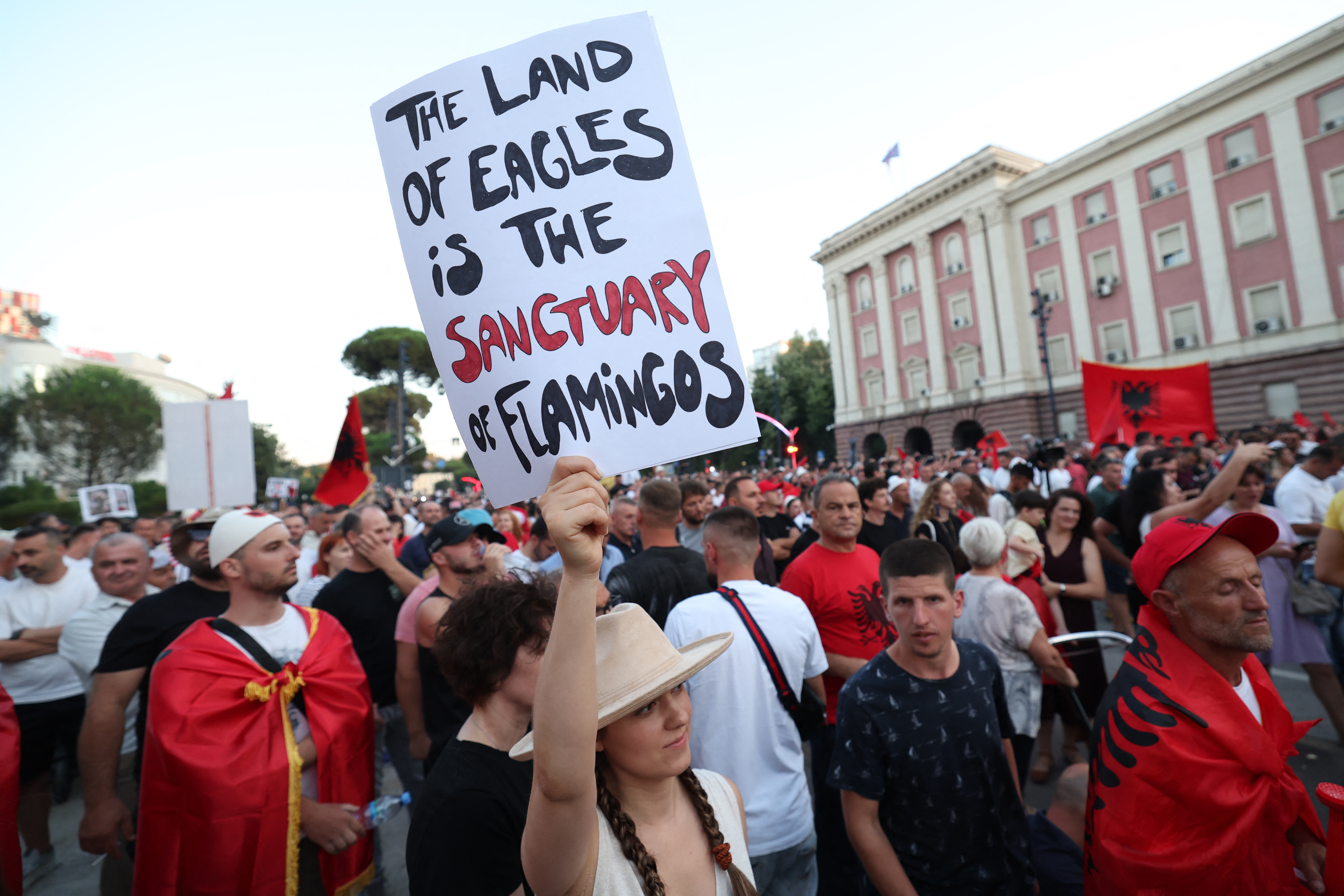 Protesters carry placards as they demonstrate in front of the Albanian Prime Minister's Office against the construction of a luxury resort near a protected natural area on Albania's southern coast, in Tirana, on July 4, 2026.