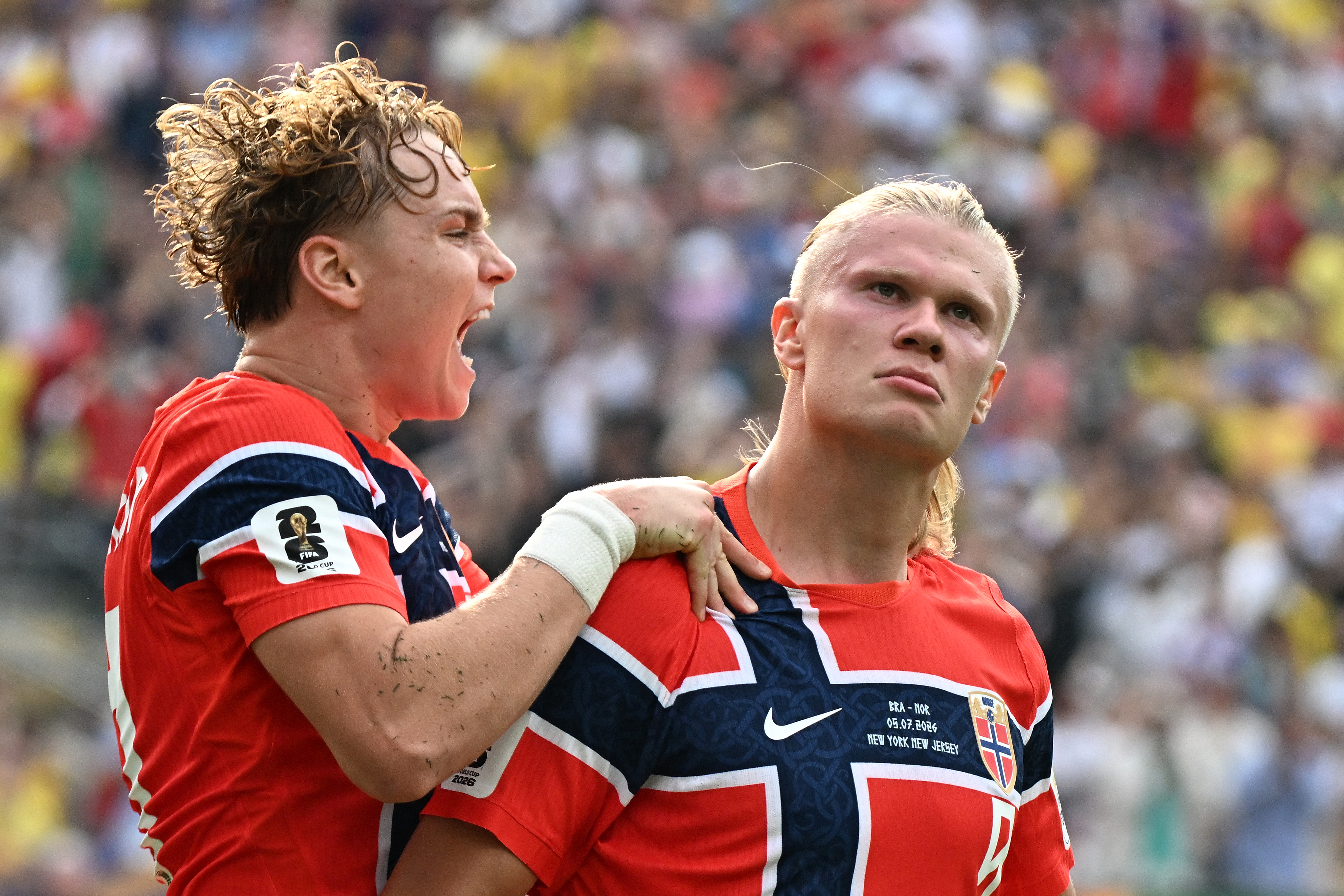 Norway's forward #09 Erling Braut Haaland (R) celebrates scoring his team's first goal with teammate midfielder #21 Andreas Schjelderup during the 2026 World Cup round of 16 football match between Brazil and Norway at the New York/New Jersey Stadium in East Rutherford on July 5, 2026.