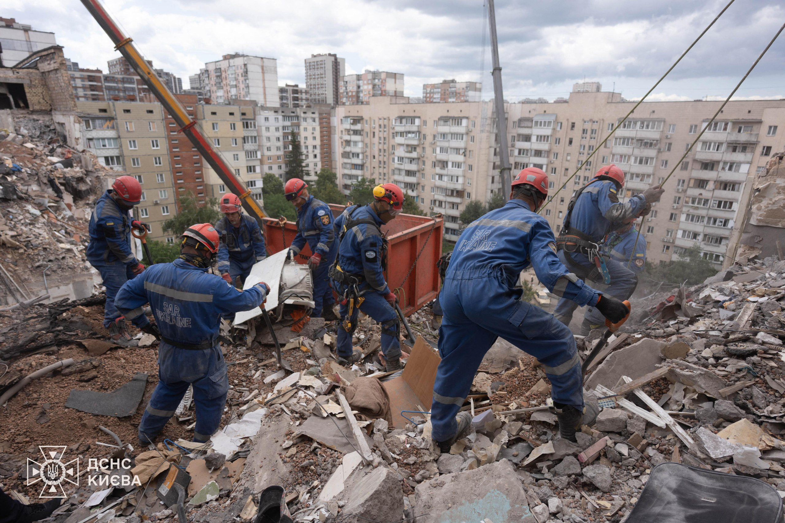 This handout picture taken and released by Ukrainian State Emergency Service on July 6, 2026 shows rescuers working on a residential building partially destroyed as a result of Russian missile strike on the Ukrainian capital of Kyiv, amid the Russian invasion in Ukraine [AFP]