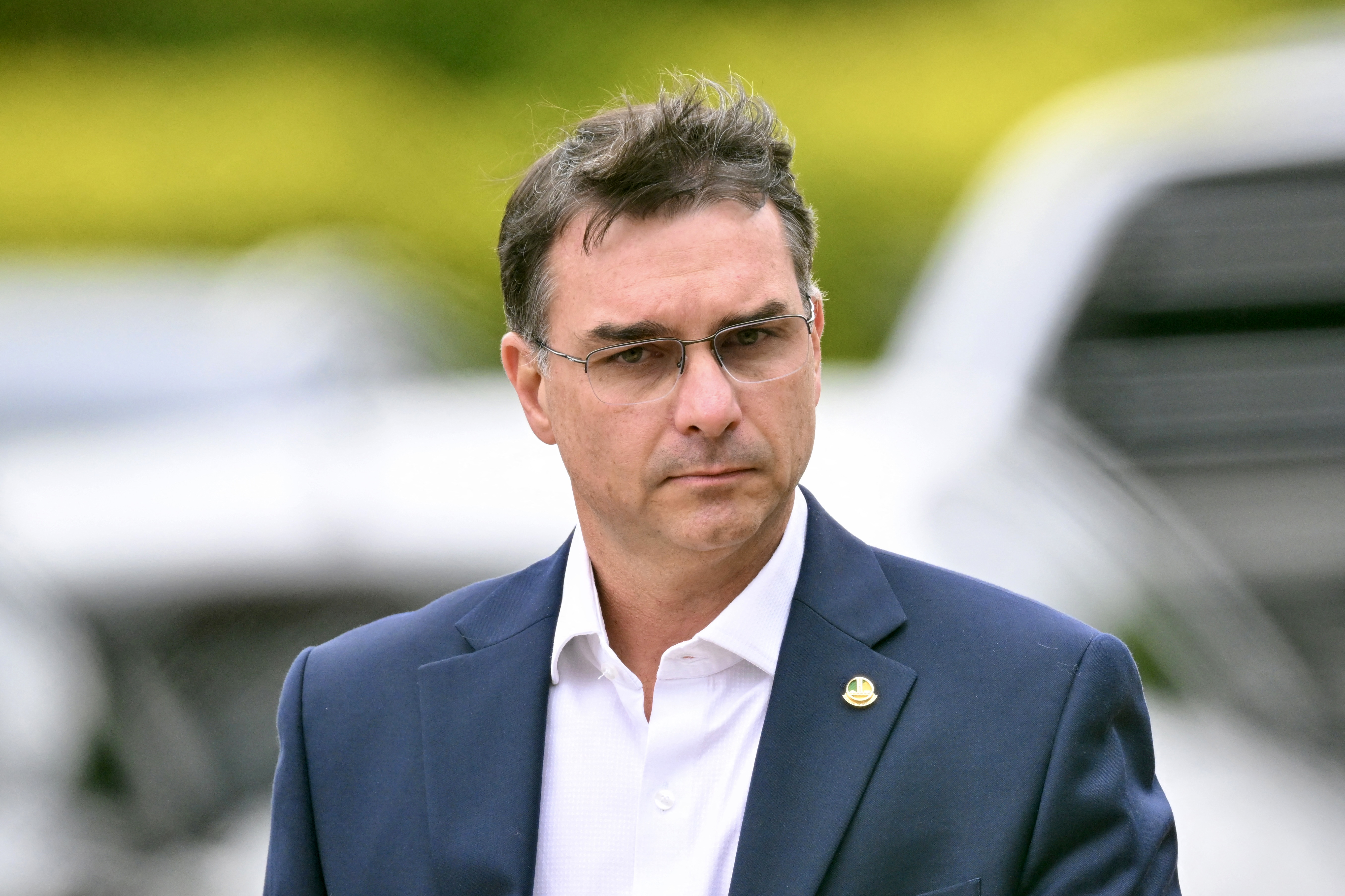 (FILES) Senator Flavio Bolsonaro, son of former Brazilian president Jair Bolsonaro, leaves the Federal Police headquarters where Bolsonaro is being held, in Brasilia, on November 25, 2025.