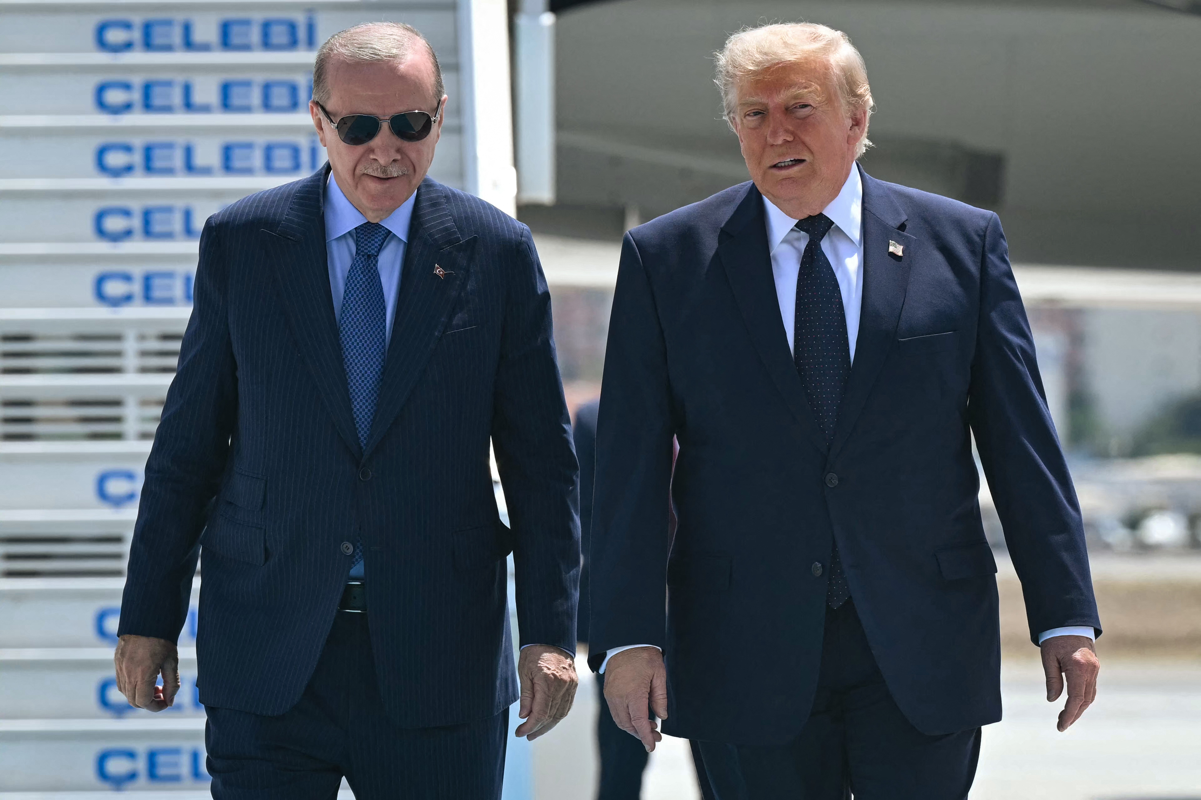 Turkish President Recep Tayyip Erdogan (L) welcomes US President Donald Trump (C) upon his arrival on Air Force One at Etimesgut Air Base near Ankara, on July 7, 2026, before attending the 36th NATO Heads of State and Government Summit.