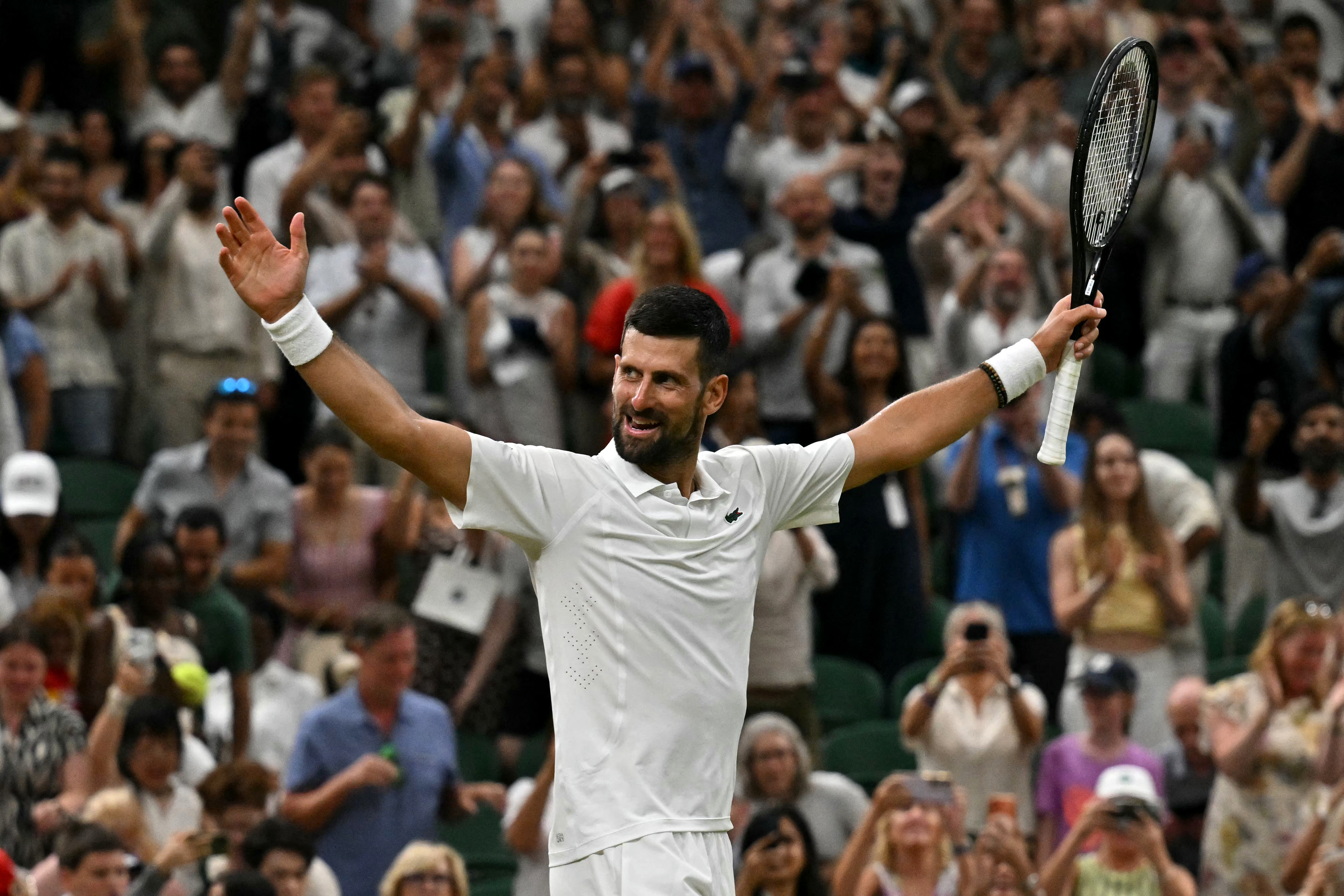 Serbia's Novak Djokovic celebrates winning against Canada's Felix Auger-Aliassime during their men's singles quarter-final tennis match on the ninth day of the 2026 Wimbledon Championships at The All England Lawn Tennis and Croquet Club in Wimbledon, southwest London, on July 7, 2026. (Photo by Glyn KIRK / AFP) / RESTRICTED TO EDITORIAL USE